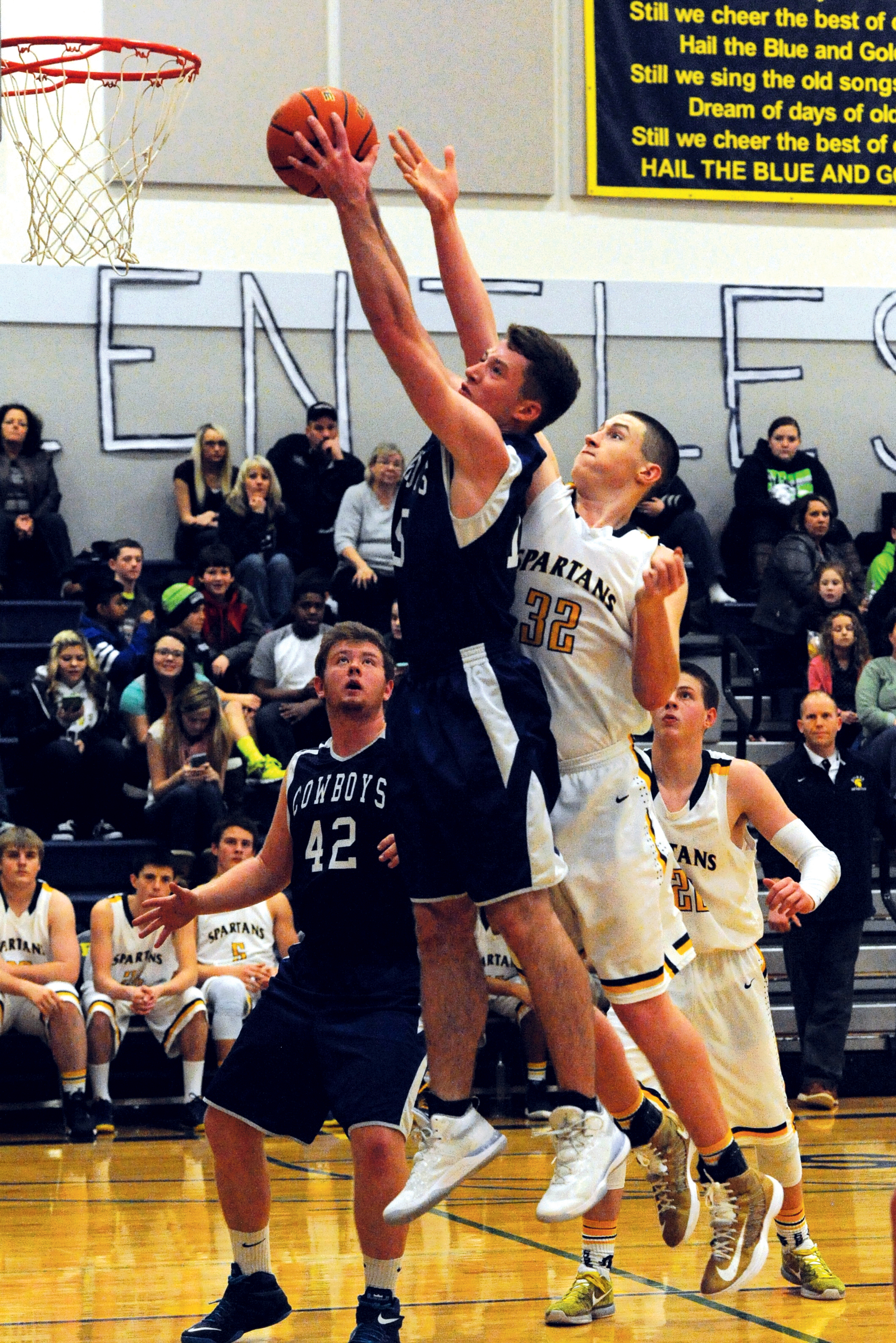 Chimacum's Sam Golden (15) rebounds in front of Forks' Marky Adams (32). Also in on the action are Chimacum's Lane Dotson (42) and Forks' Parker Browning