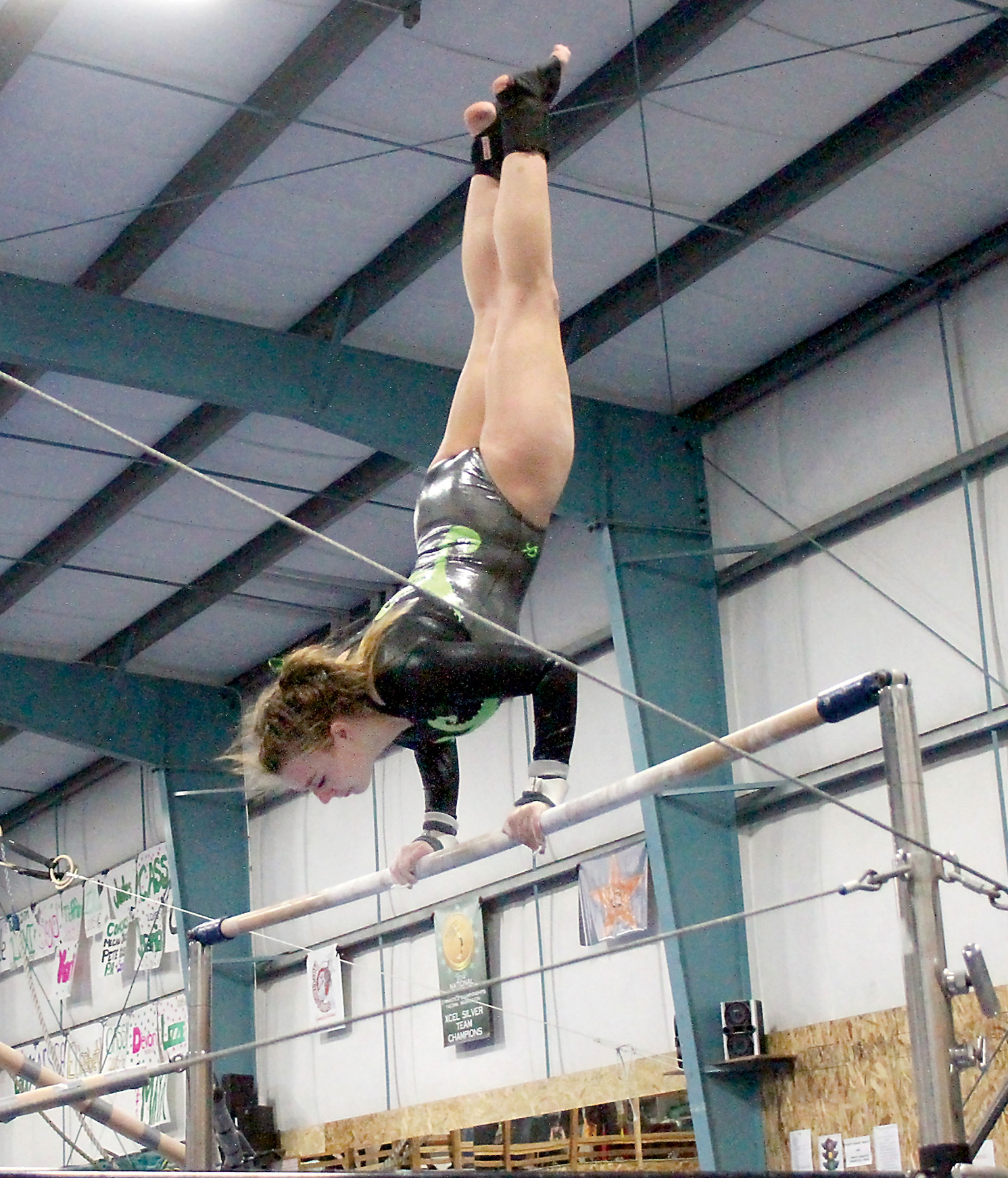 Port Angeles' gymnast Lexi Hefton competes on the uneven bars. Hefton won the event after receiving a score of 8.1. She finished third in the all-around at the meet. (Daniel Horton/for Peninsula Daily News)