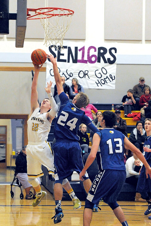 Forks' Parker Browning scores against Elma's Elijah Martin (24) and Blake Sackrider (13). The Spartans won 51-41 to earn a season sweep against the Eagles. (Lonnie Archibald/for Peninsula Daily News)