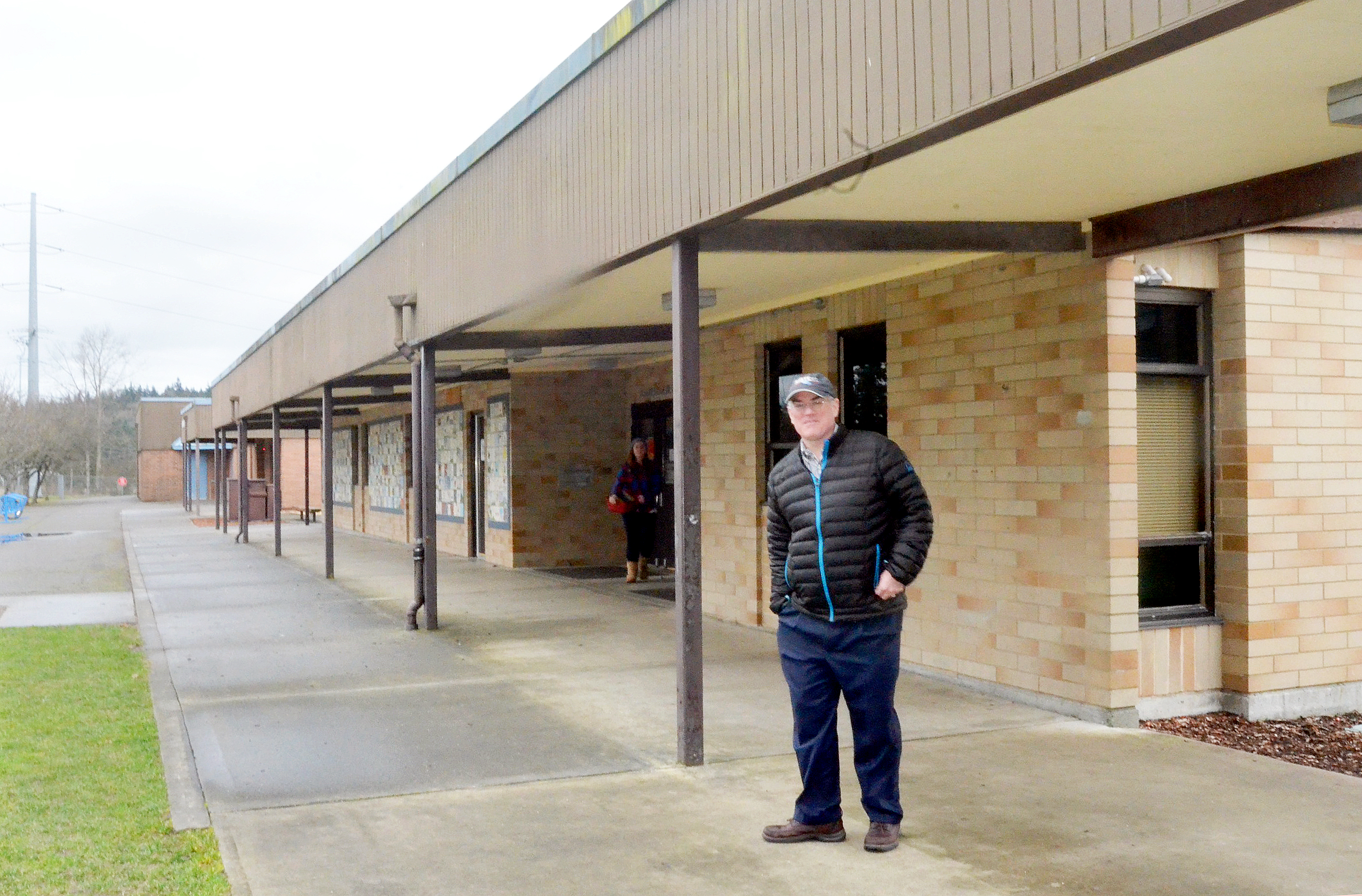 Chimacum Schools Finance Director Arthur Clark stands in front of the elementary school building that would be demolished and replaced if the school district's $34.8 million bond measure passes Feb. 10. (Charlie Bermant/Peninsula Daily News)