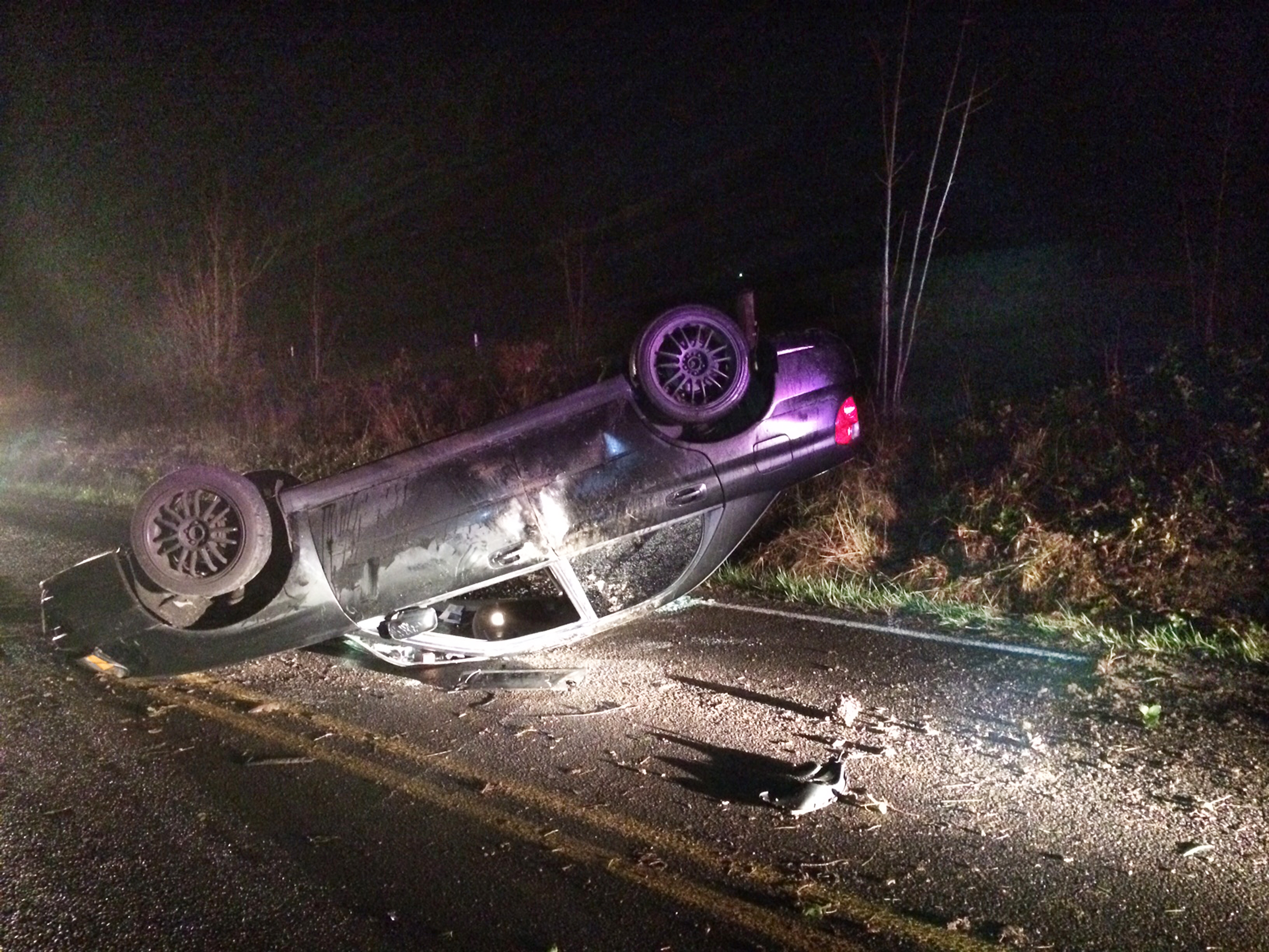 The overturned car is shown early Sunday. (Clallam County Fire District No. 2)