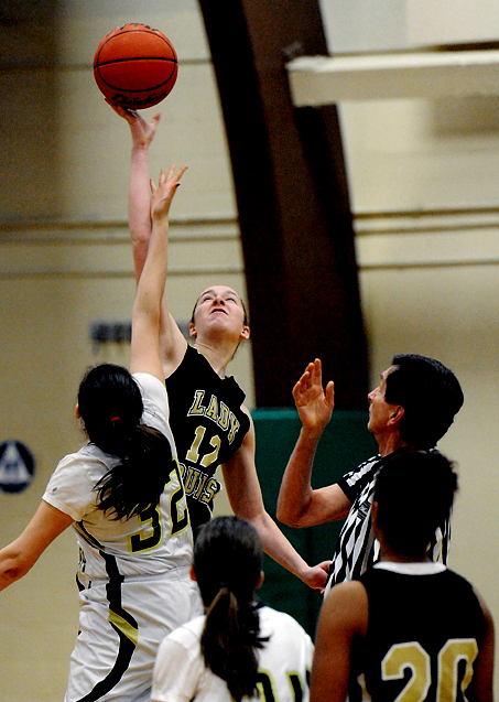 Clallam Bay's Molly McCoy (12) wins the opening tip against Northwest Yeshiva's Shlomit Menashe (32) in a Class 1B postseason tilt at Port Angeles High School. (Lonnie Archibald/for Peninsula Daily News)