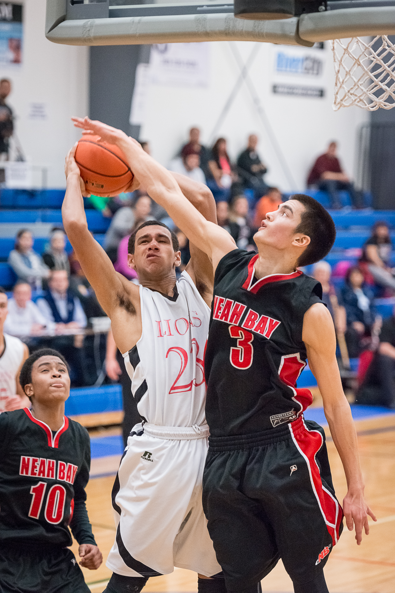 Neah Bay's Abraham Venske (10) denies Shorewood Christian's JJ Young as Neah Bay's Rwehabura Munyagi