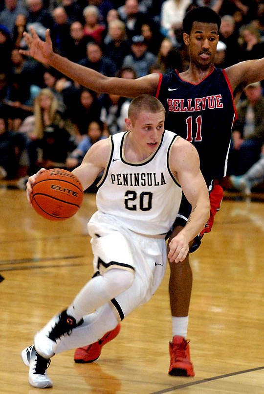 Peninsula's Chris Reis (20) drives past the defense of Bellevue's Yonathan Michael. (Keith Thorpe/Peninsula Daily News)