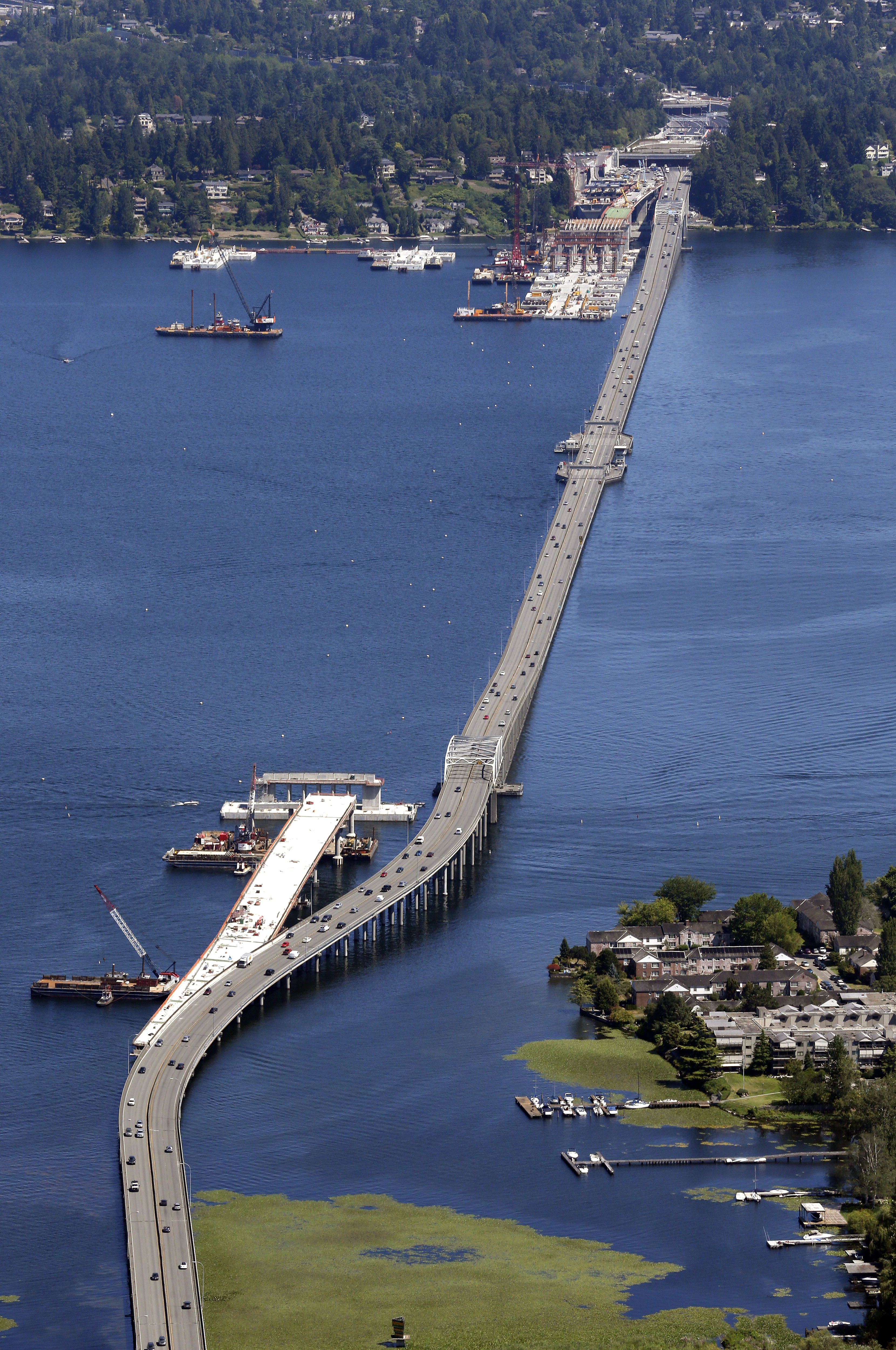 The existing Highway 520 floating bridge is seen last July next to the construction site of the new bridge where it begins in Medina