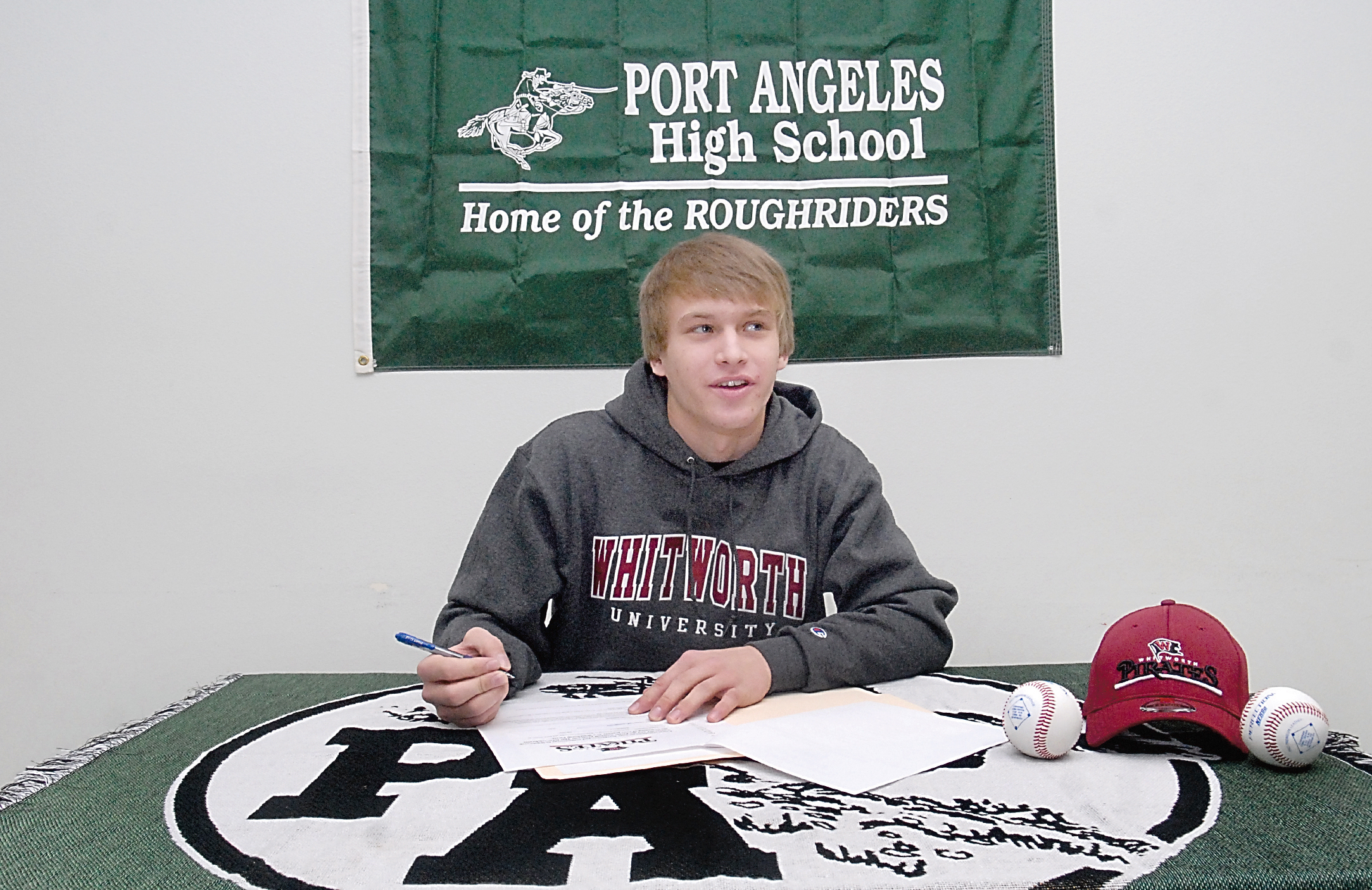 Port Angeles High School senior Logan Ciaciuch looks up after signing his letter of intent on Wednesday to play baseball at Whitworth University in Spokane. (Keith Thorpe/Peninsula Daily News)