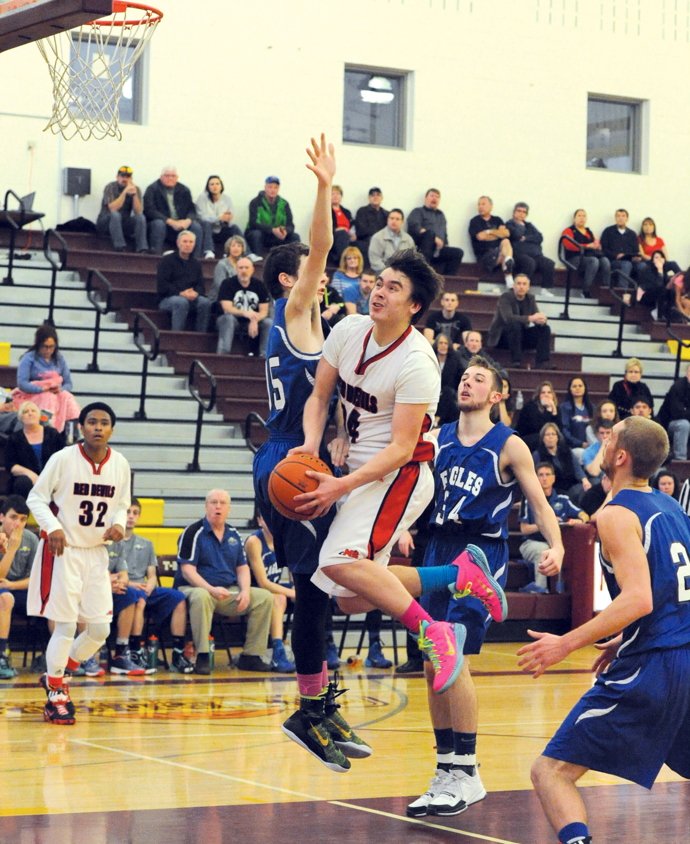 Neah Bay's Ryan Moss drives towards the basket against Three Rivers Christian's Karsten Rentner. (Lonnie Archibald/for Peninsula Daily News)