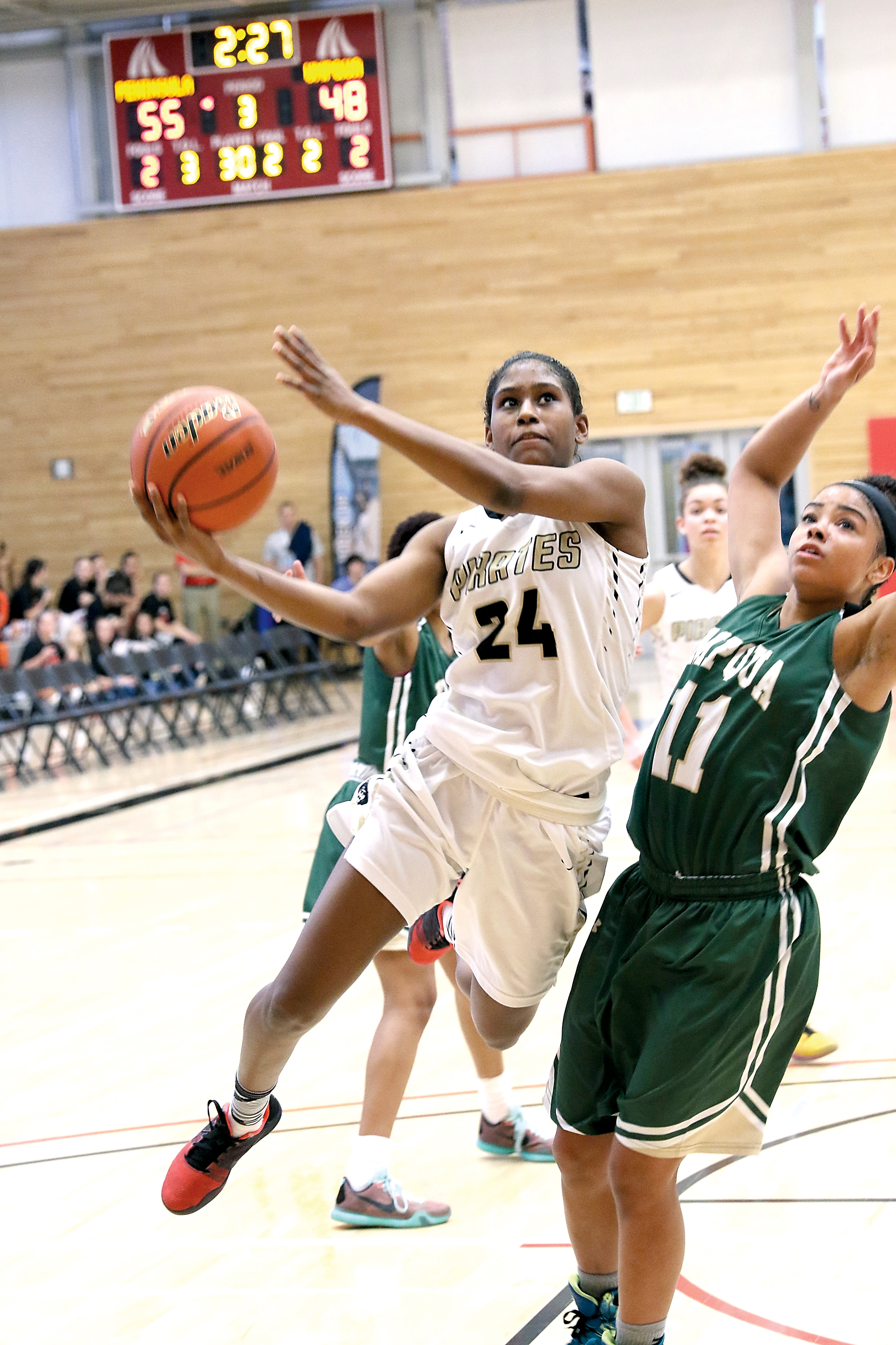 Peninsula's Imani Smith drives to the rim against Umpqua's Syd Clark during the Pirates 70-67 NWAC quarterfinal win at Everett Community College on Thursday. (Tracy Swisher/Northwest Athletic Conference)