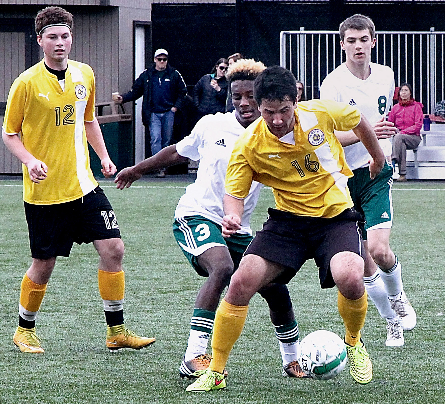 Sequim's Jerry Bryan (16) and Port Angeles' Miki Andrus fight for control of the ball Saturday at Wally Sigmar Field in Port Angeles. Also in on the play are Sequim's Will Bittner (12) and Port Angeles' Grayson Peet (8). (Dave Logan/for Peninsula Daily News)