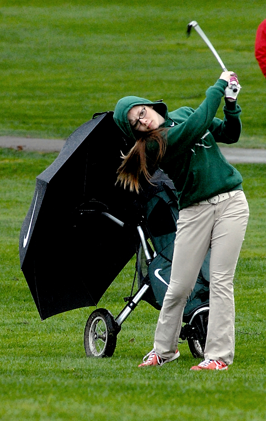 Port Angeles golfer Rose Shinn-Clark swings from the fairway on the first hole at Peninsula Golf Club. (Keith Thorpe/Peninsula Daily News)