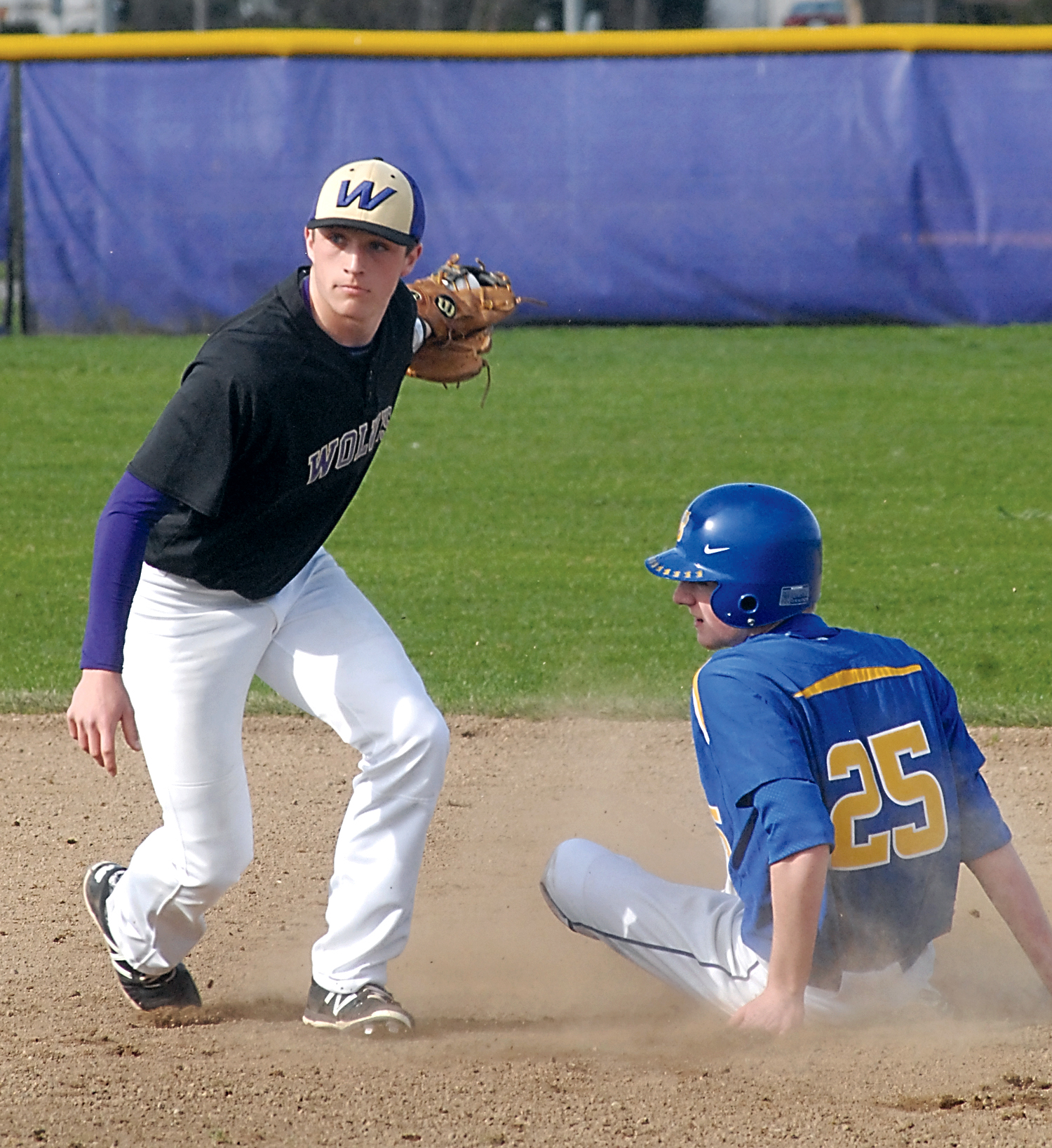 Sequim shortstop Evan Hurn looks to the umpire after applying a late tag on Bremerton's Luke McMillan's steal of second base. (Keith Thorpe/Peninsula Daily News)