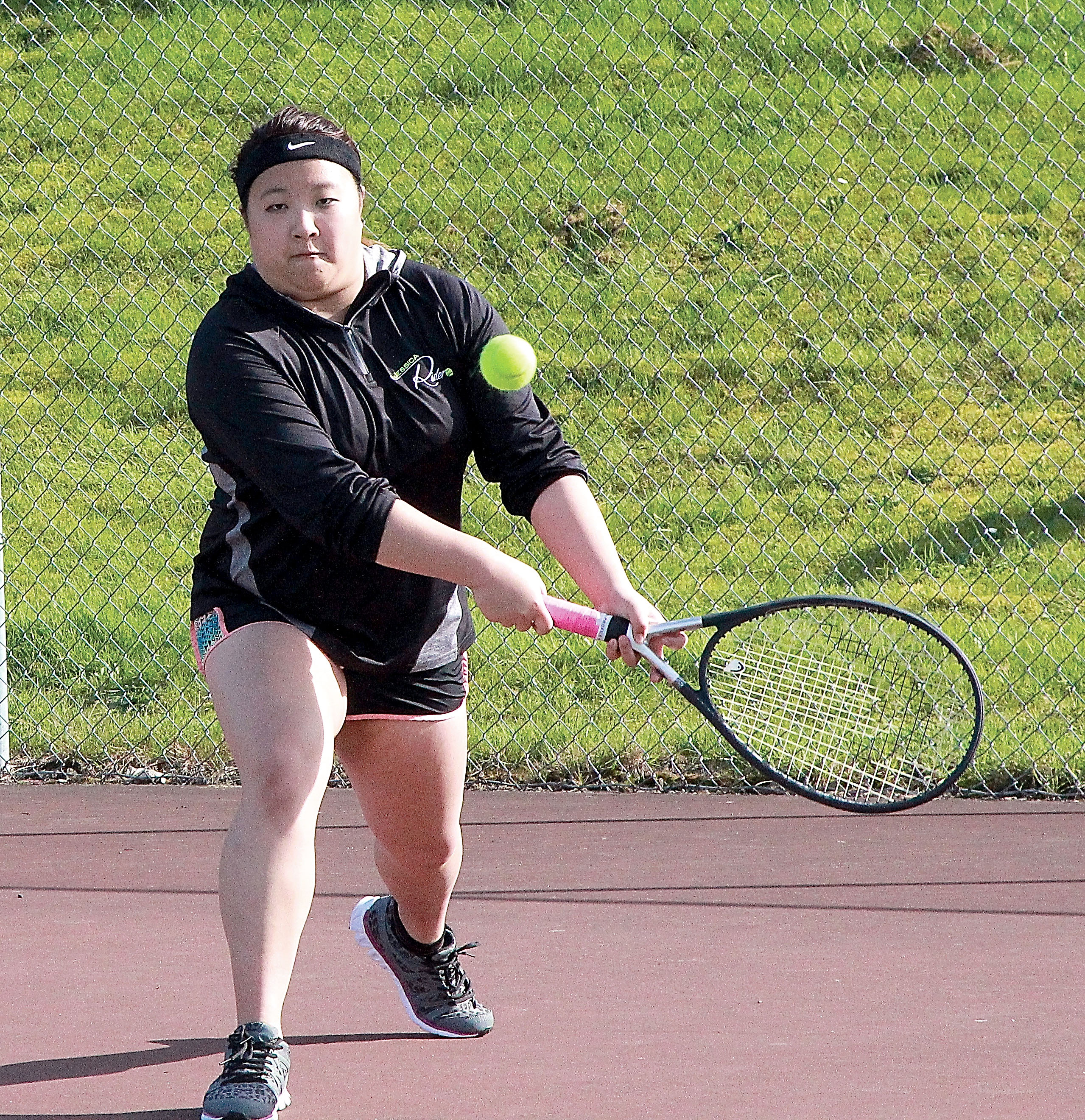 Port Angeles' Jessica Zhu prepares to return a shot by Olympic's Melina Johnson during their singles match at Port Angeles High School. Zhu fell 6-0