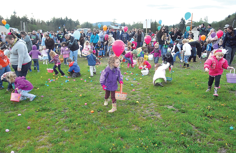 Children scramble through an egg-filled field at the annual KONP Easter egg hunt in 2014 at The Pumpkin Patch west of Sequim. Hundreds of children hunted for thousands of prize-filled eggs with a drawing for additional prizes after the hunt. (Keith Thorpe/Peninsula Daily News)