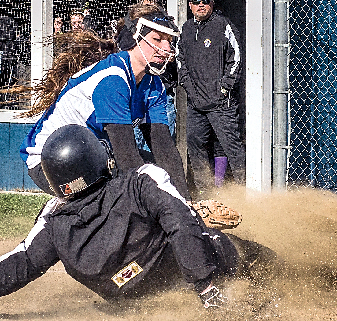 Quilcene's Sammy Rae slides under the tag of Chimacum pitcher Ryley Eldridge's glove at home plate after a wild pitch in the top of the second inning. Chimacum rallied to win 16-12 in five innings. (George Leinonen/for Peninsula Daily News)