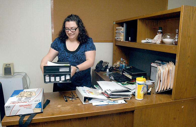 Housing Resource Center Supervisor Veronica Fountain arranges her desk after unpacking at the new Serenity House Housing Resource Center at 520 E. First St. in Port Angeles on Tuesday. The center