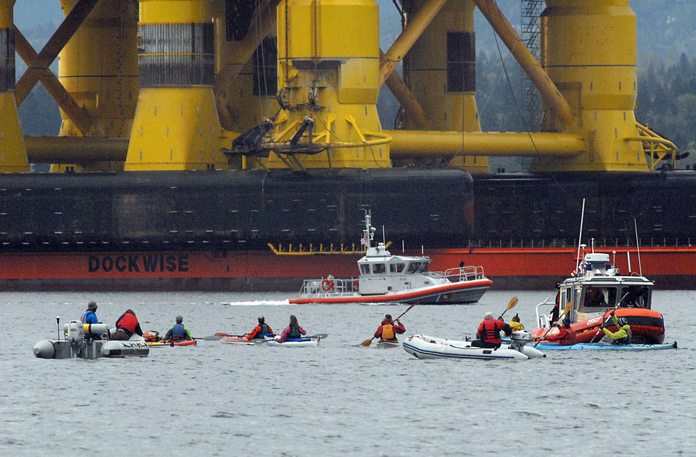 U.S. Coast Guard patrol boats warn protesters in kayaks not to intrude upon the safety zone imposed around the Polar Pioneer and Blue Marlin in Port Angeles Harbor. (Keith Thorpe/Peninsula Daily News)