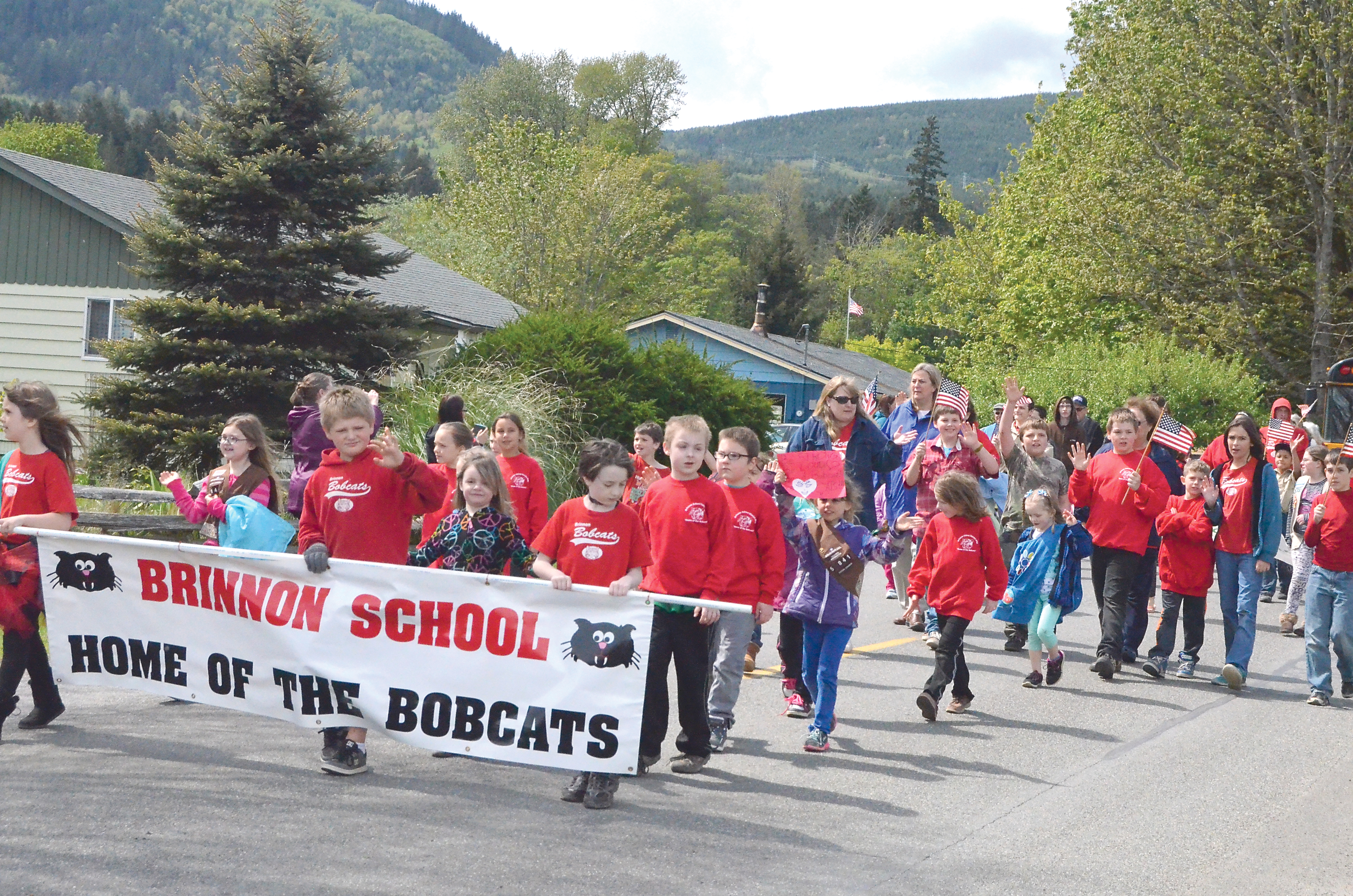 Students and adults representing Brinnon Elementary School march in the Loyalty Day Parade. (Charlie Bermant/Peninsula Daily News)