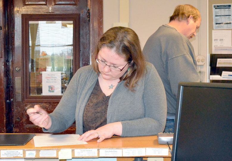 Amy Smith fills out paperwork while filing for a position on the Port Townsend City Council on Wednesday. Also pictured is Ken McEdwards