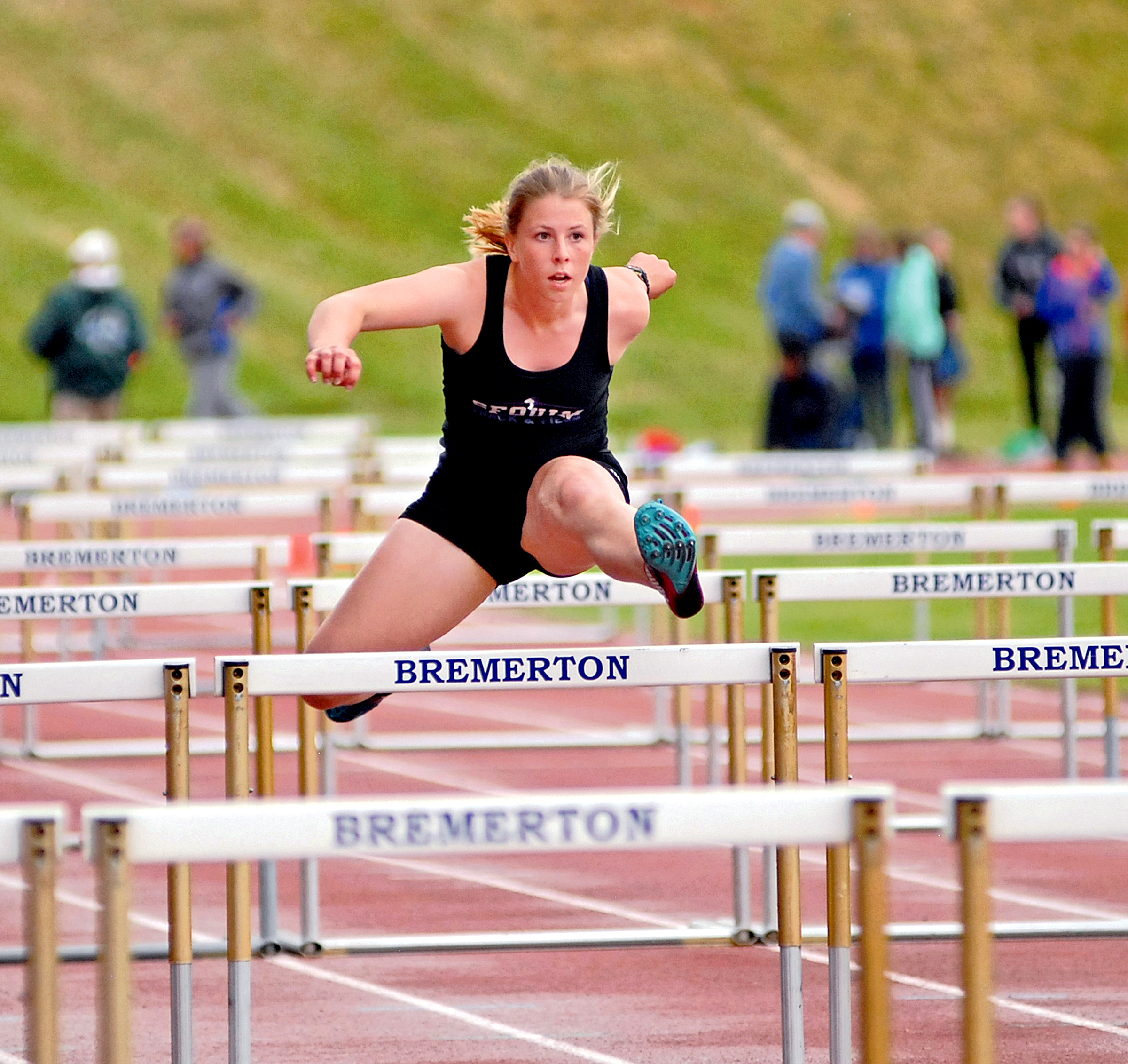 Sequim's Mattie Clark bounds in the air during the 100-meter hurdles at Bremerton High School. Clark placed third to earn a spot at the district meet. (Chris Tucker/Central Kitsap Reporter)