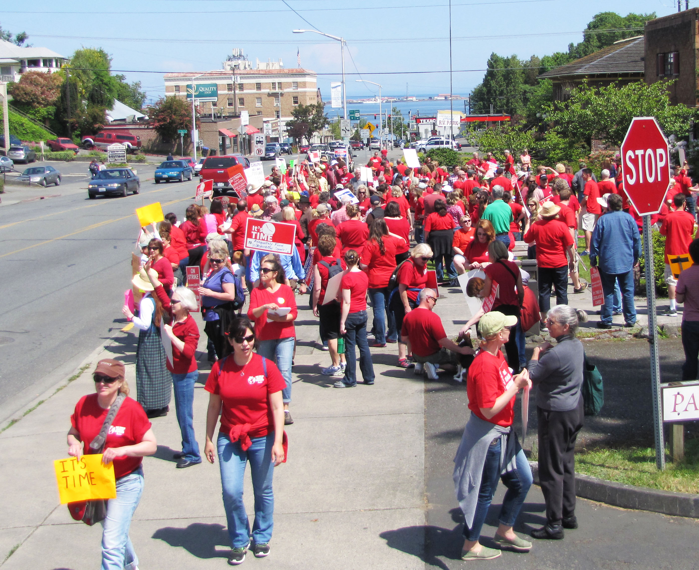 Some of the 300 Port Angeles and Sequim teachers staging a one-day work stoppage gather along Lincoln Street at midday today. (Arwyn Rice/Peninsula Daily News)