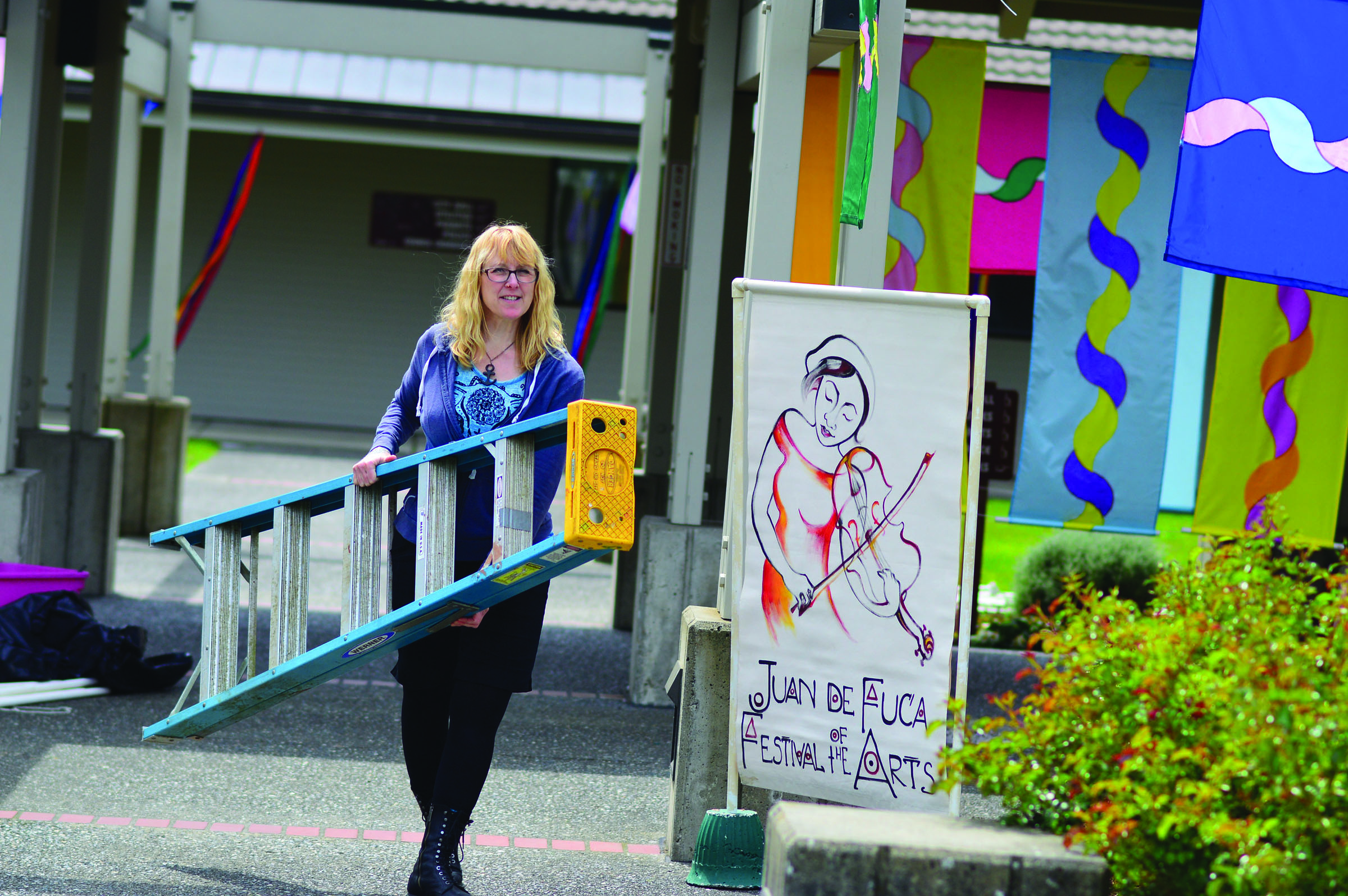 Juan de Fuca Festival volunteer Jeanette Painter is part of the setup process Thursday at Port Angeles' Vern Burton Community Center. (Diane Urbani de la Paz/Peninsula Daily News)