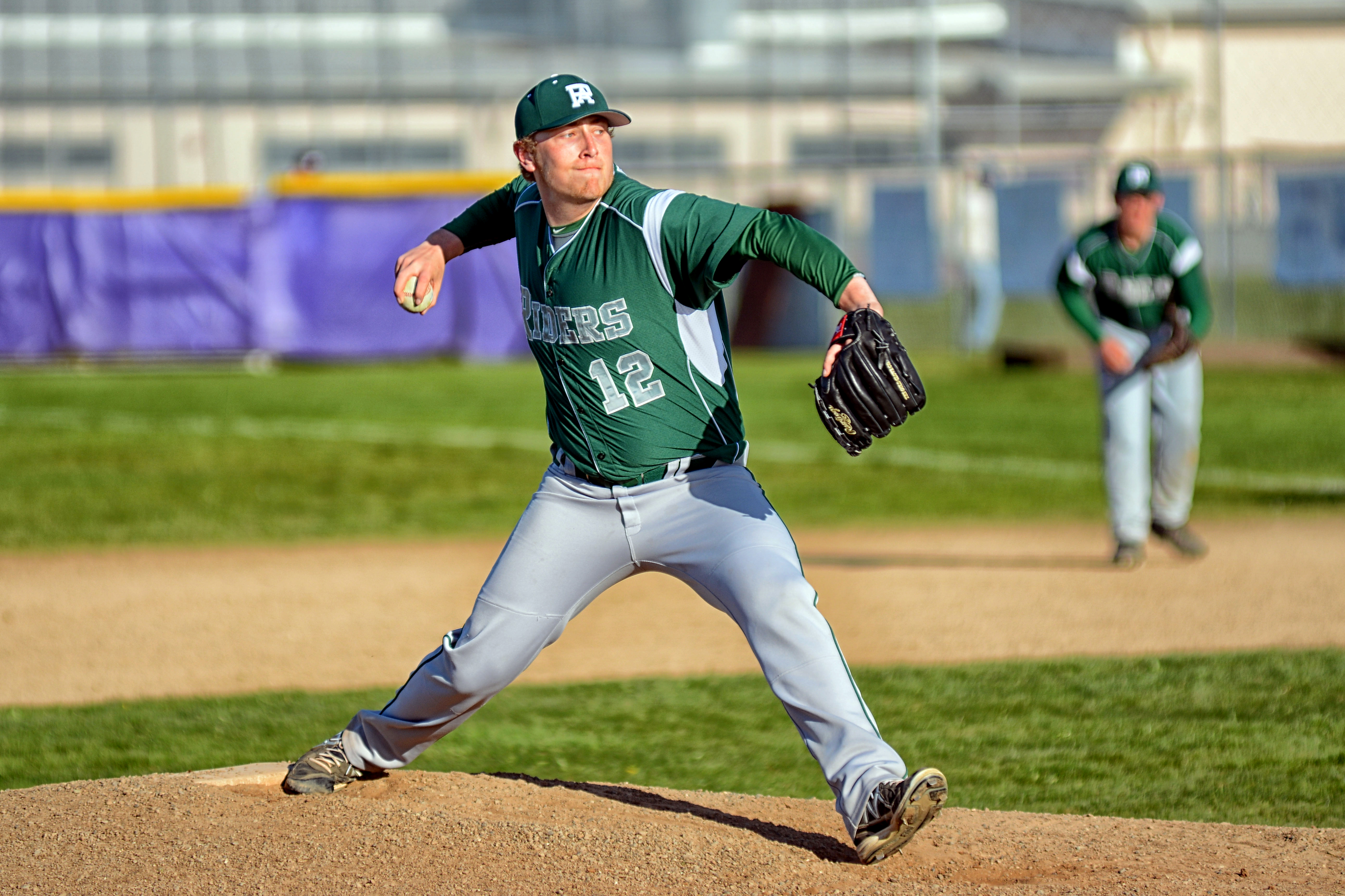 Port Angeles' Travis Paynter throws a pitch against Sequim. Paynter was the ace of a staff that had three all-league honorees and led the Roughriders to the state regional round. (Jay Cline/for Peninsula Daily News)