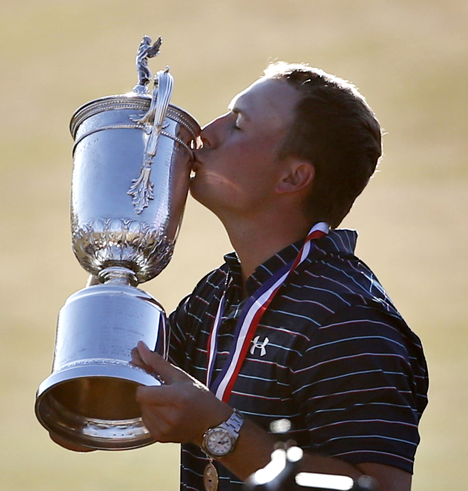 Jordan Spieth kisses the trophy after winning the the U.S. Open golf tournament at Chambers Bay on Sunday  in University Place. (The Associated Press)