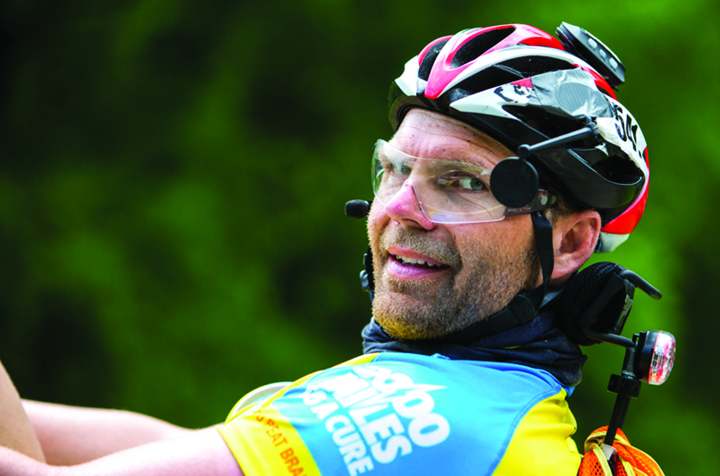 Rob DeCou glances over for a portrait while riding towards Athens