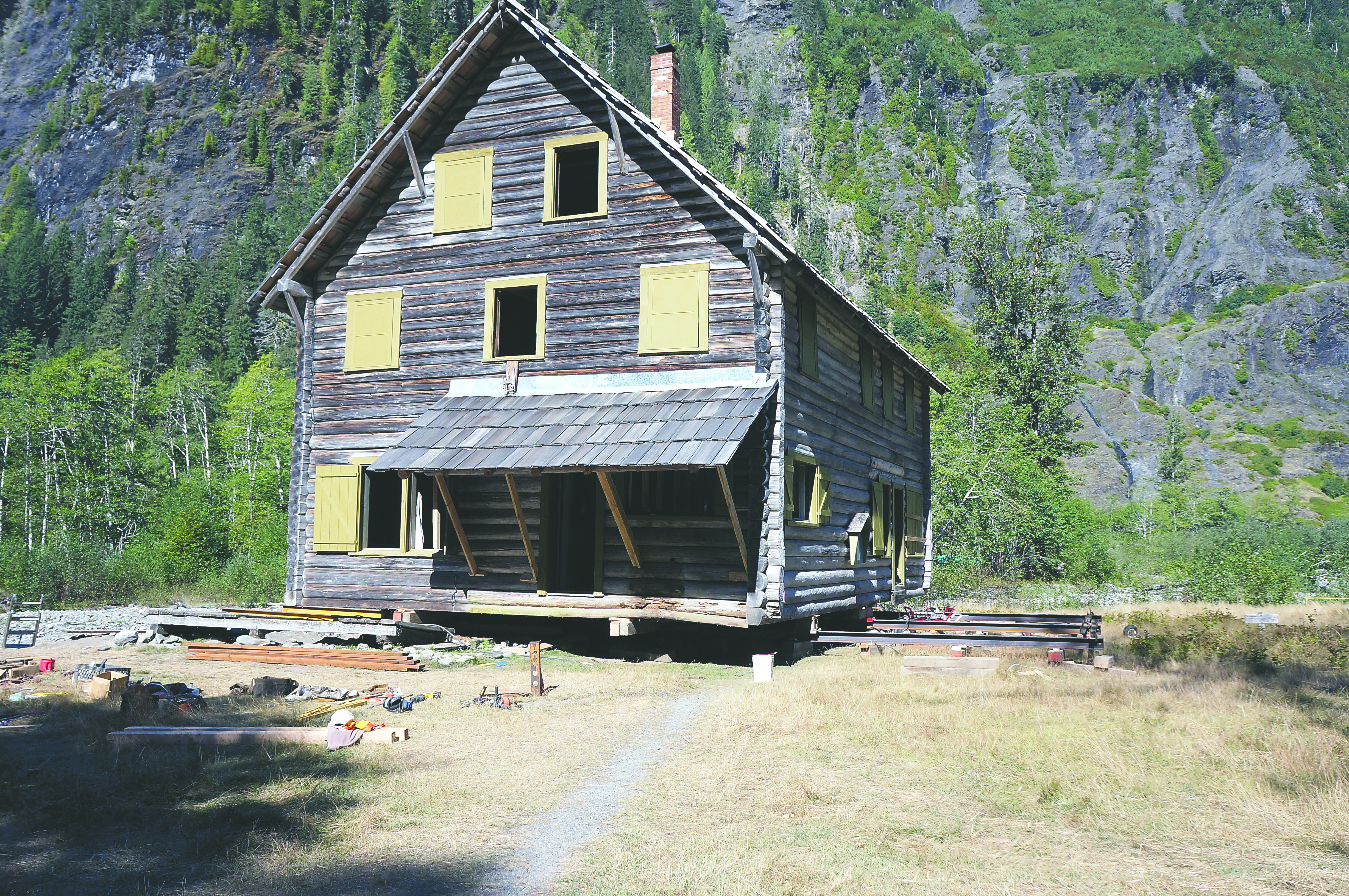 The Enchanted Valley chalet rests on steel beams during work to push the structure back from the banks of the Quinault River in September 2014. (National Park Service)