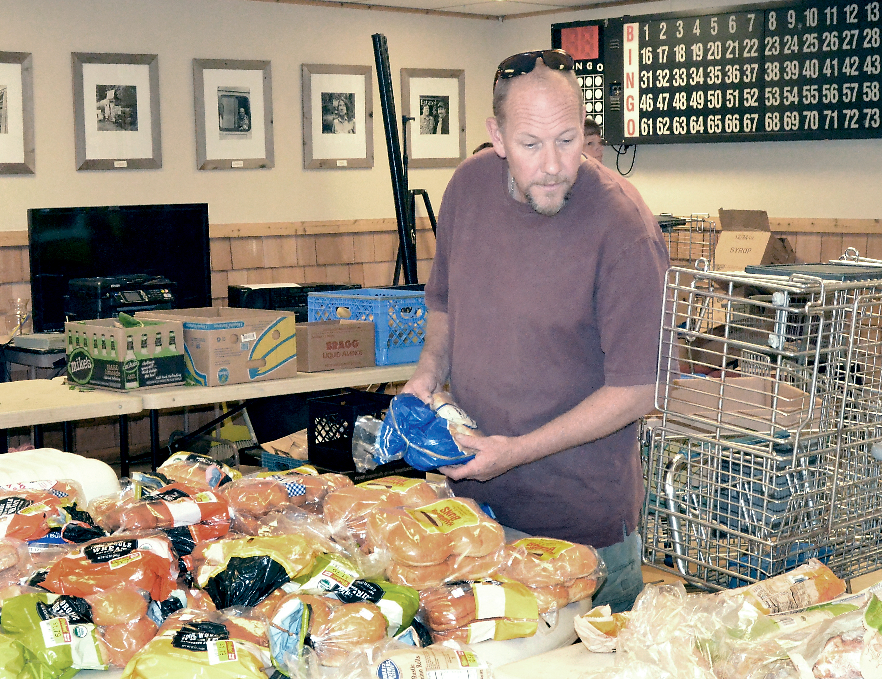 Tod Nickerson picks out some bread at the Quilcene Food Bank on Wednesday. Charlie Bermant/Peninsula Daily News