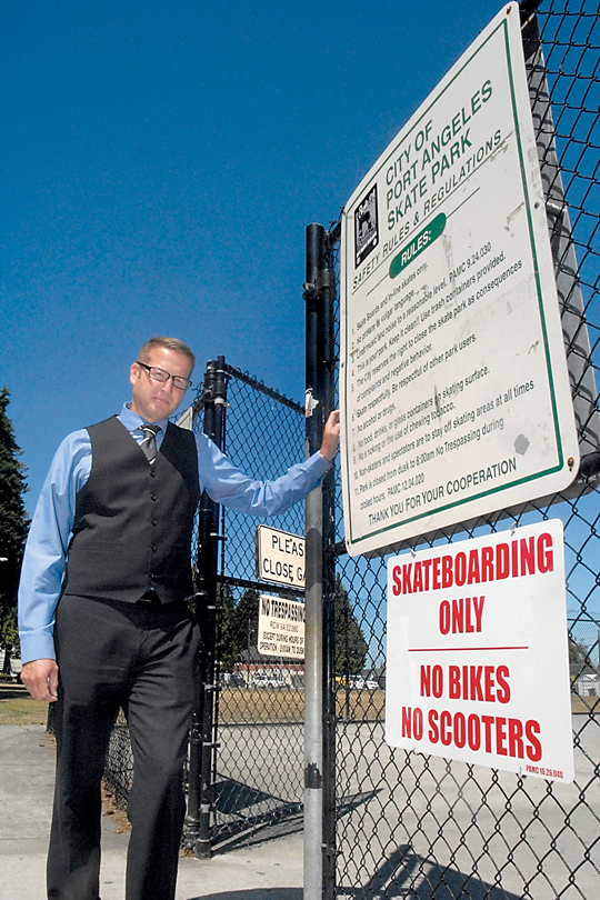 Port Angeles Parks Superintendent Corey Delikat stand next to a sign banning bicycles and scooters at the Port Angeles Skate Park at Erickson Playfield on Thursday. Park officials will close the park for three days next week because of rule infractions by bicyclists and scooter riders. Keith Thorpe/Peninsula Daily News