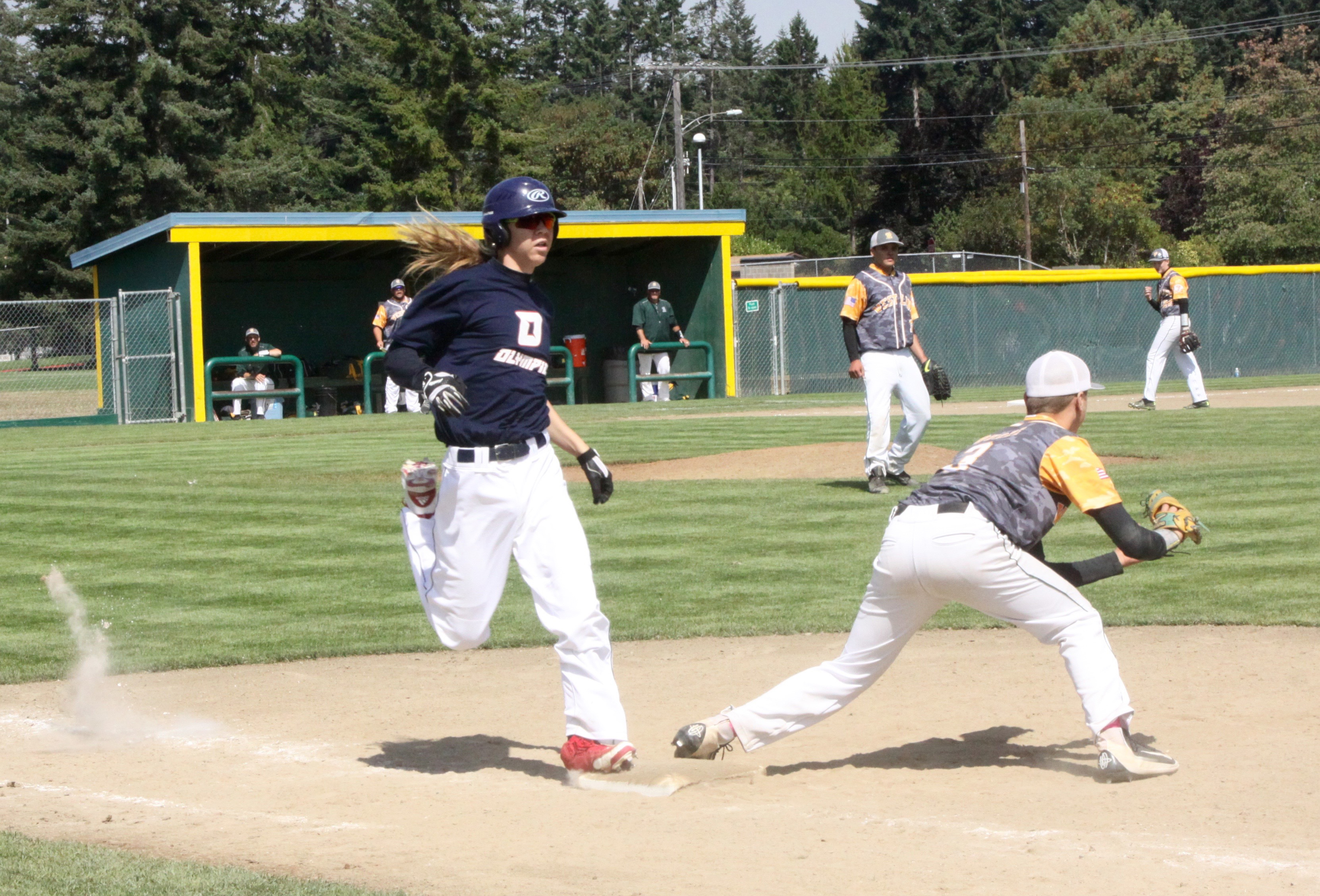 Olympic's Derek Bowechop is beaten to first base by the throw to West Linn