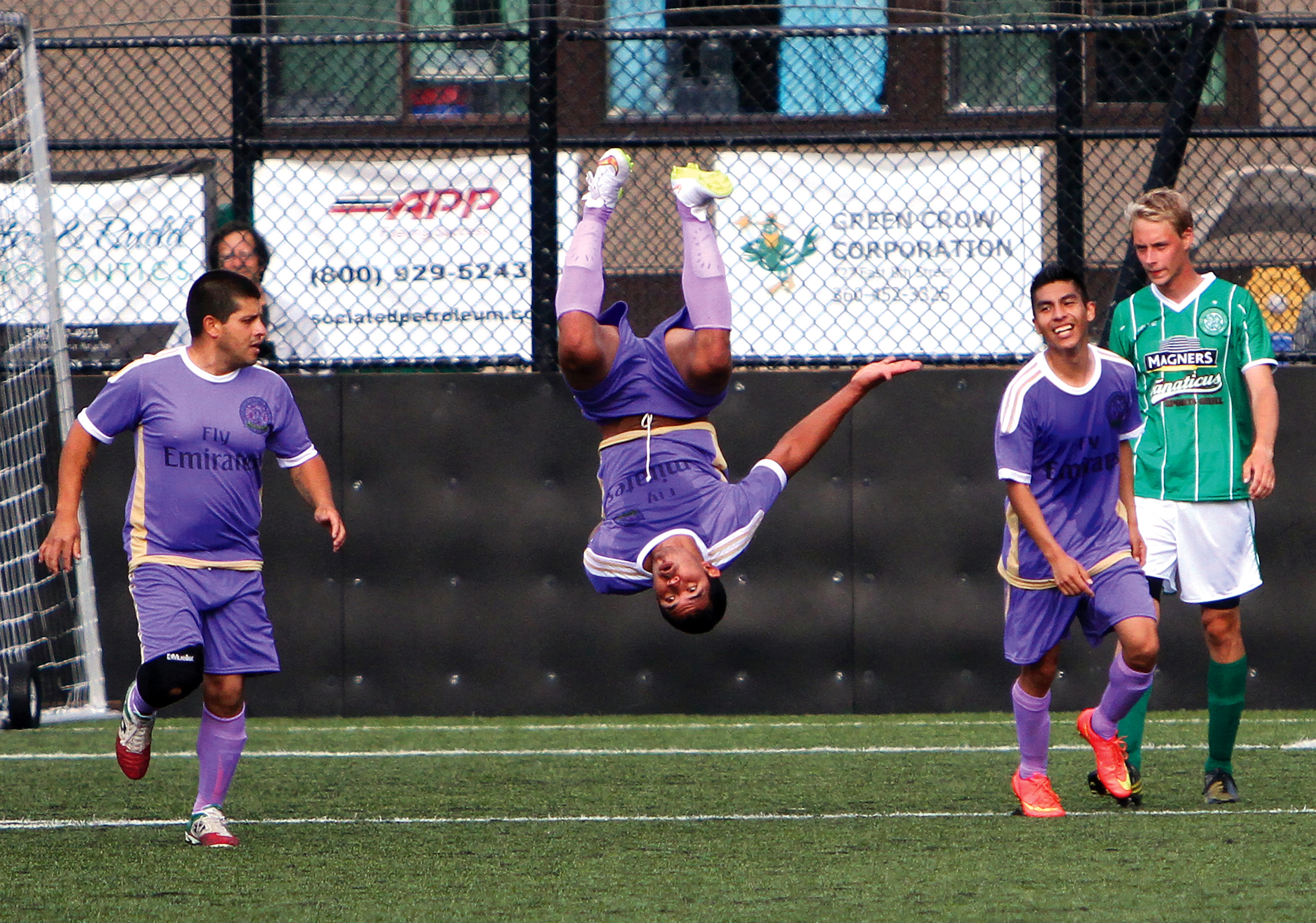 Sequim FC's Pablo Salazar celebrates his goal in the first half with a backflip as teammates Juan Gonzalas