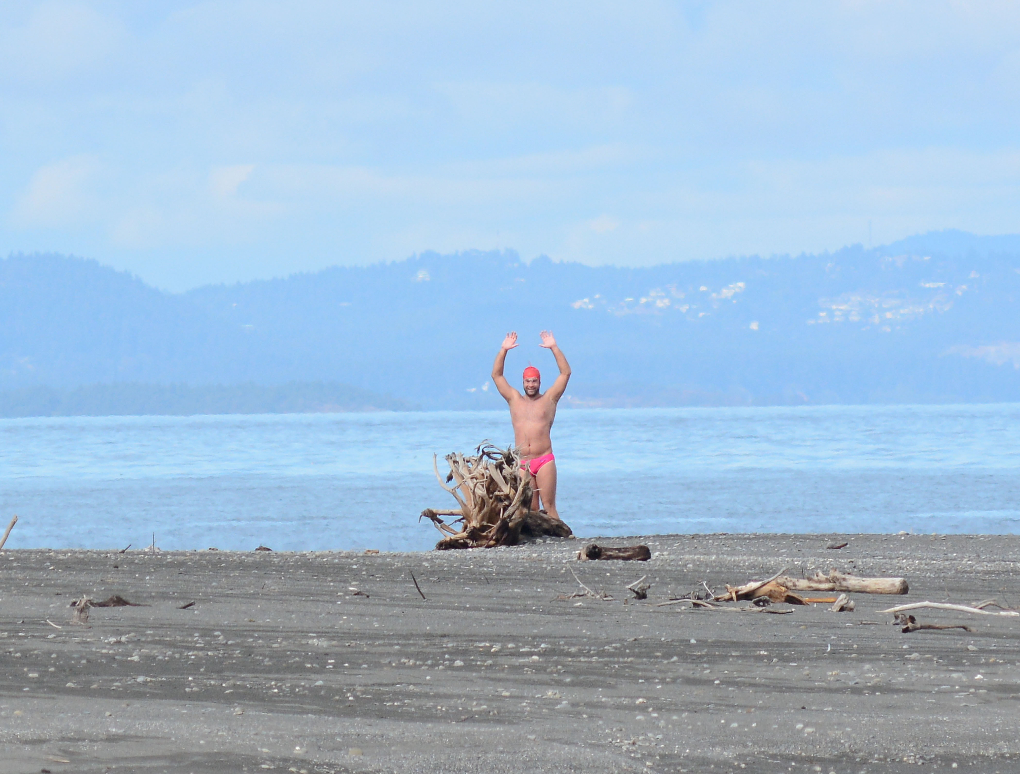 Andrew Malinak celebrates the completion of his swim across the Strait of Juan de Fuca after reaching the mouth of the Elwha River on Sunday. Jay Cline