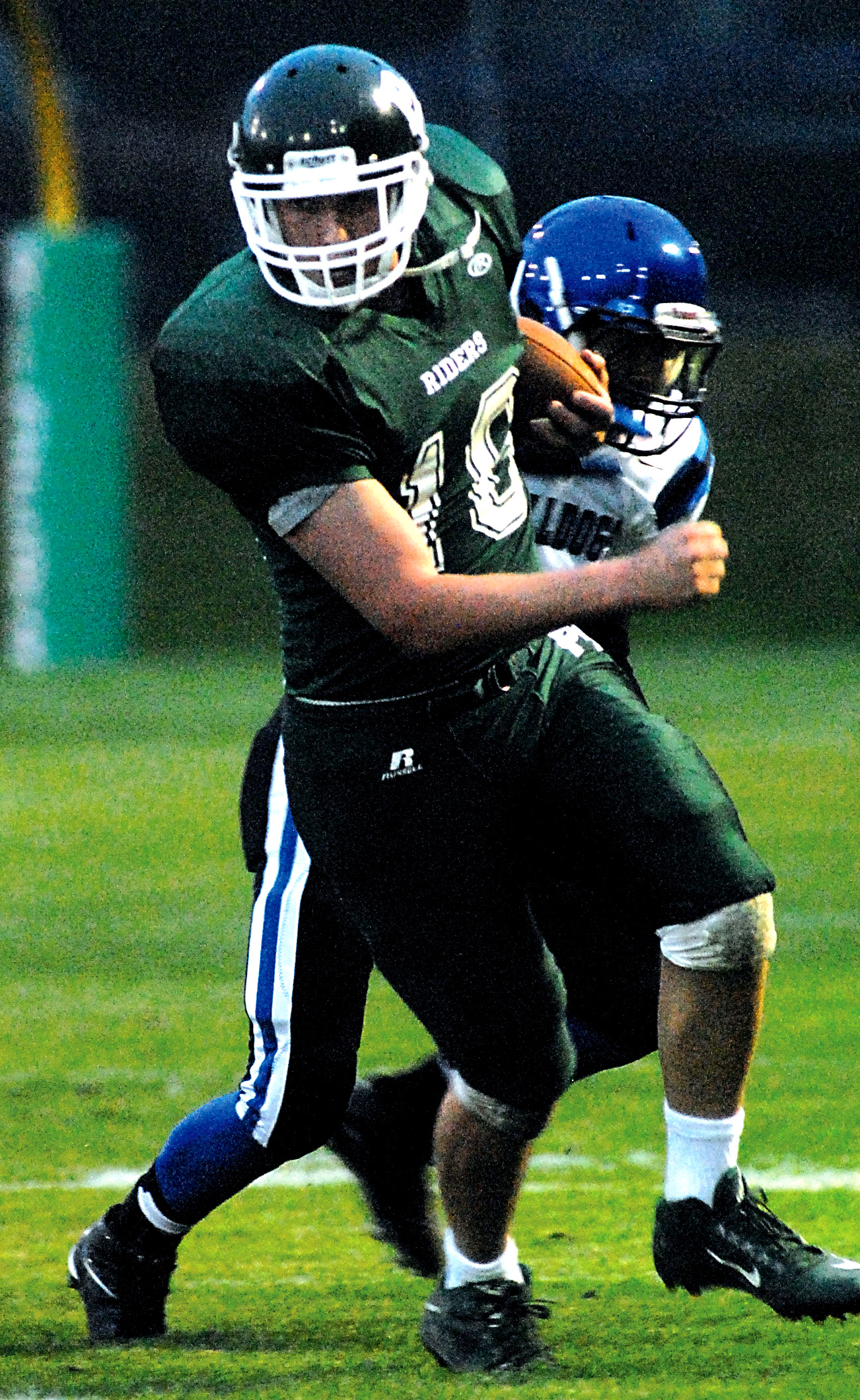 Port Angeles' Kellen Landry tries to escape the tackle of North Mason's Trey Fisher. Keith Thorpe/Peninsula Daily News