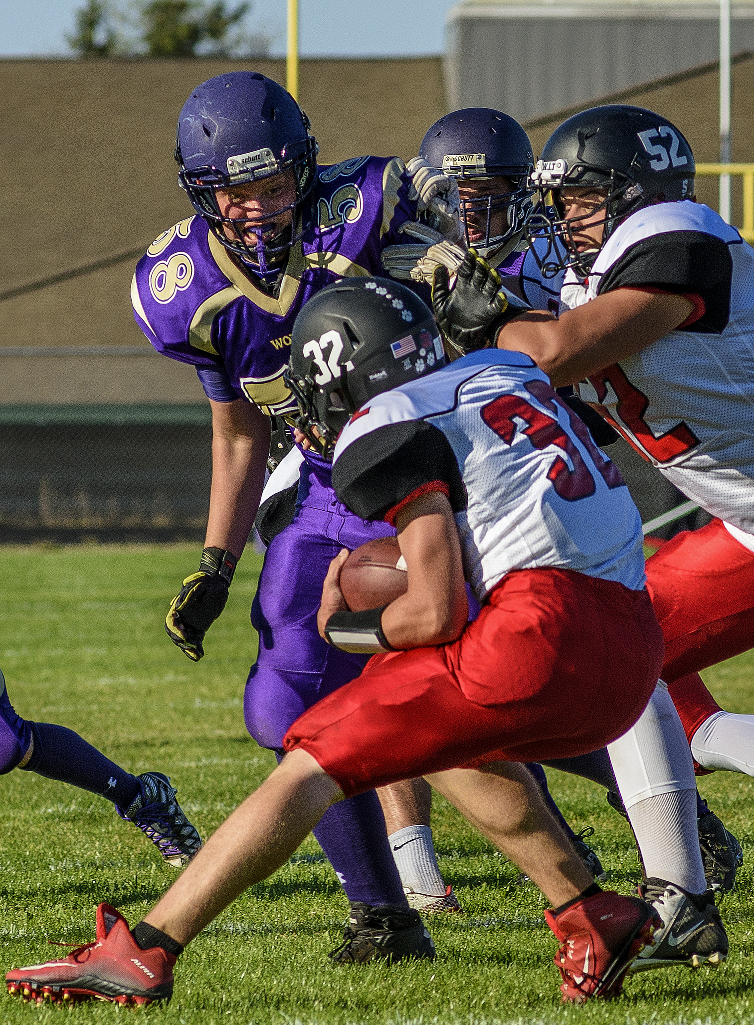 Sequim's Matthew Schock (58) tangles with Coupeville lineman Jacob Martin (52) while trying to track down running back Jacob Martin (32) earlier this season. George Leinonen/for Peninsula Daily News