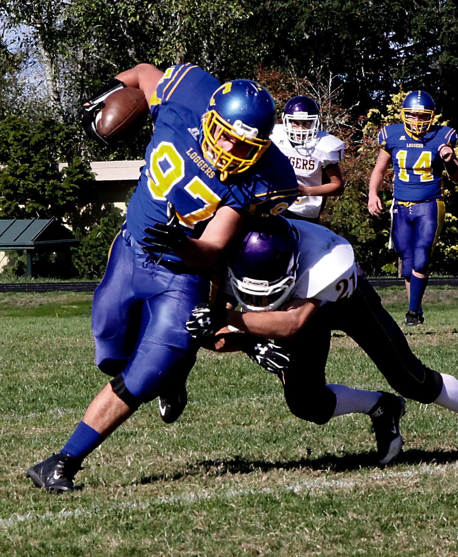 Crescent's McCabe Story (97) tries to escape a tackle by Quilcene's Andy Johnston after catching a pass from quarterback Neil Peppard (14). Dave Logan/for Peninsula Daily News