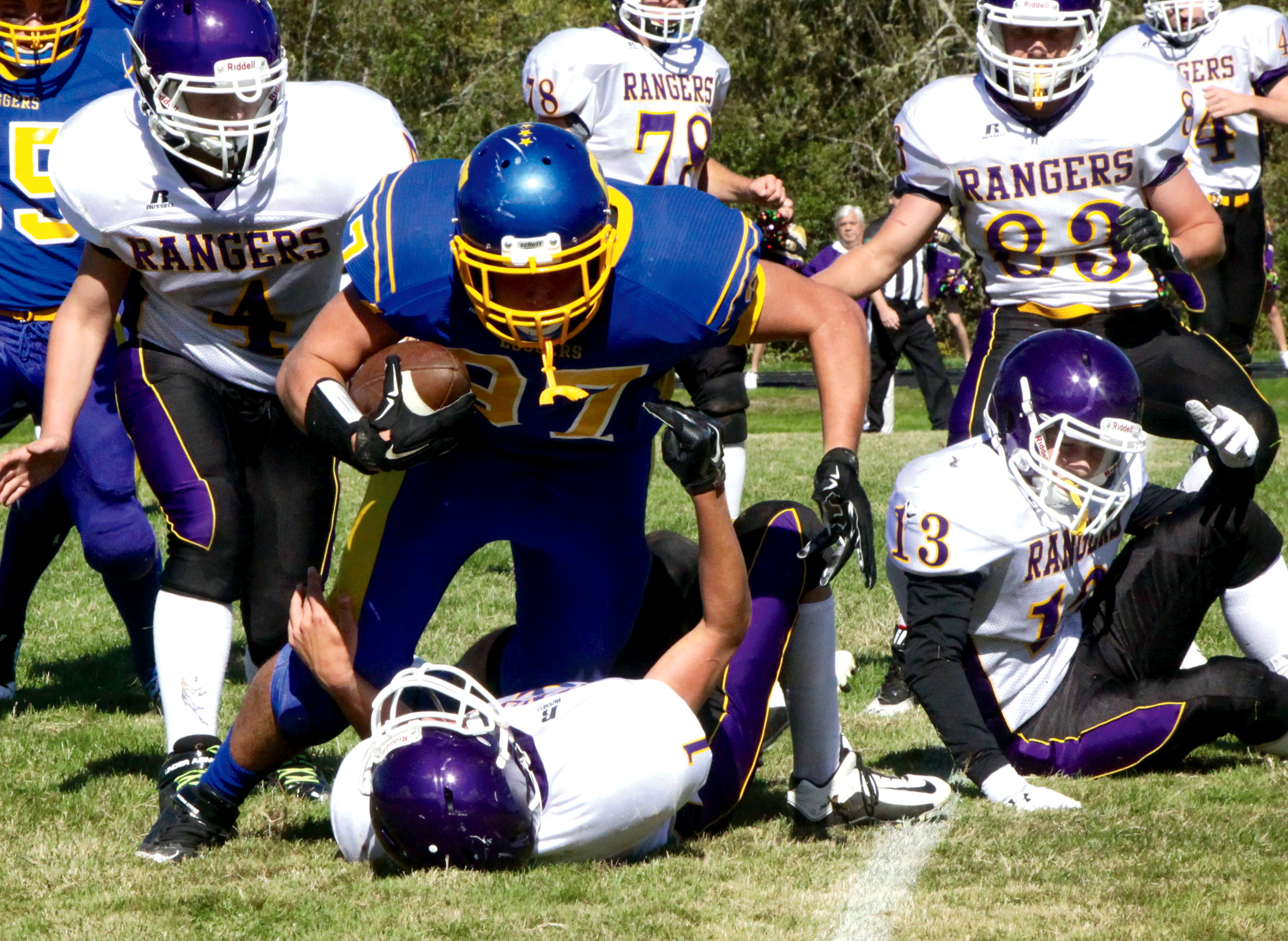 Crescent's McCabe Story (97) tries to run over Quilcene's Ace Elkins (1) during the Rangers' 50-8 win over the Loggers last week. Dave Logan/for Peninsula Daily News