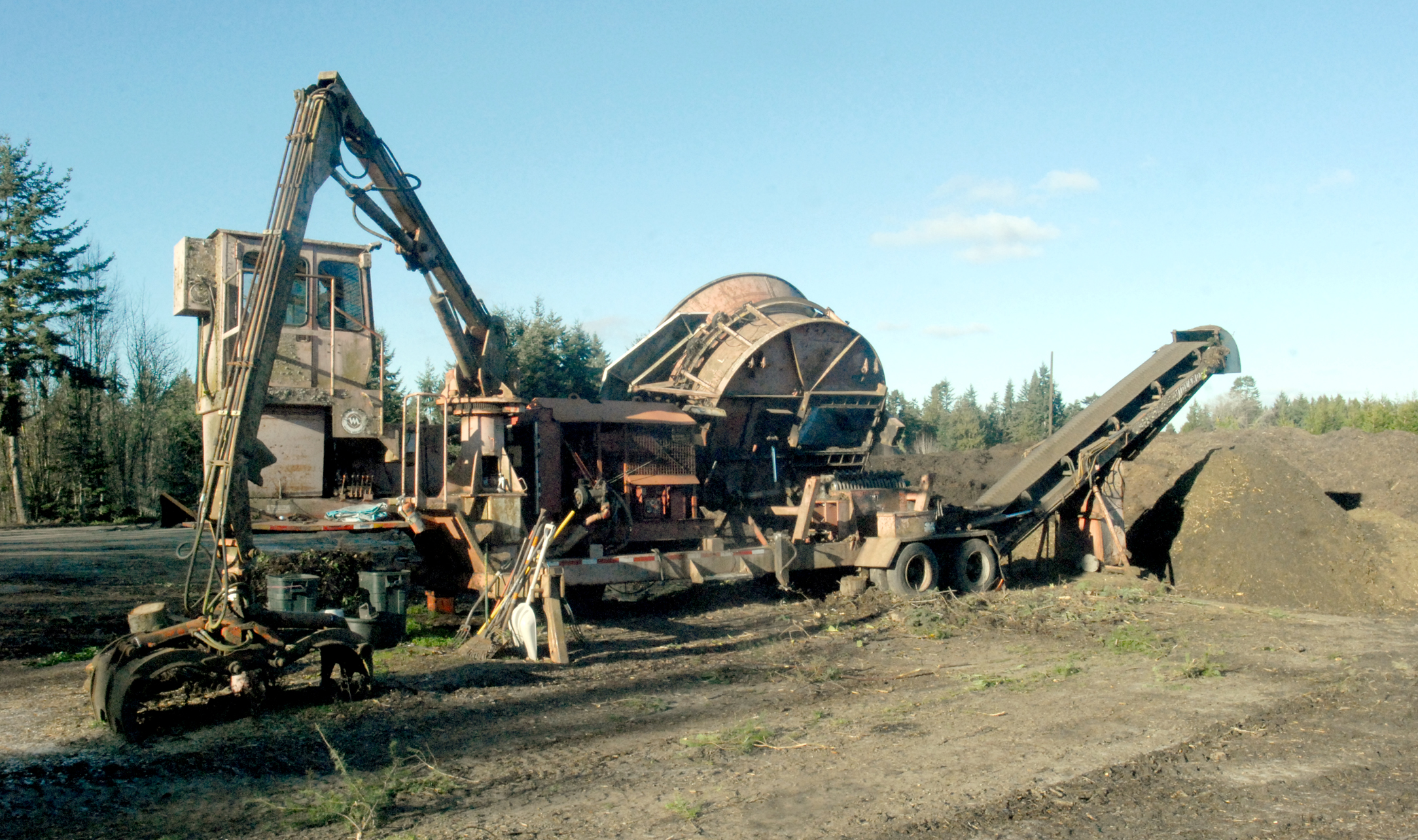 A grinding machine sits waiting for recycled Christmas trees