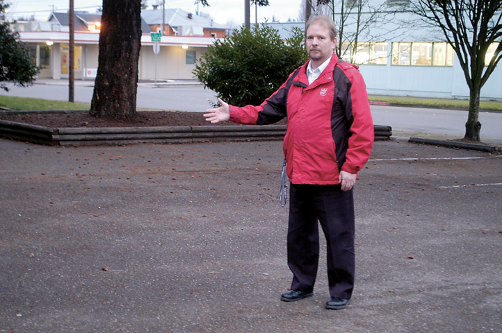 Major John Tumey of the Port Angeles Salvation Army stands in a now empty parking lot where a group of squatters were recently cleared. — Chris McDaniel/Peninsula Daily News ()