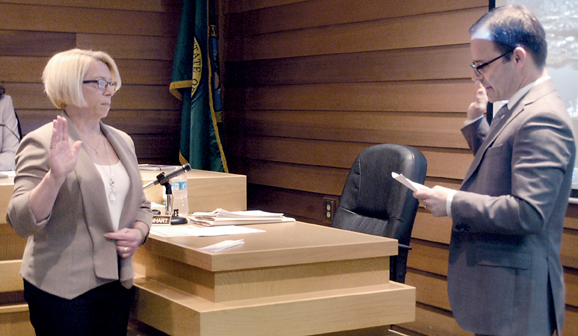 Port Commissioner Connie Beauvais is sworn in Tuesday morning at the beginning of the regular Port of Port Angeles meeting by port counsel Simon Barnhart. — Chris McDaniel/Peninsula Daily News. ()