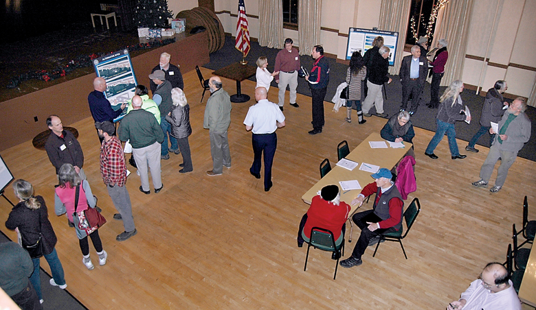 Members of the public look at displays and talk with military representatives during Tuesday's open house on Navy plans to build a submarine escort pier and support buildings on Ediz Hook. (Paul Gottlieb/Peninsula Daily News)