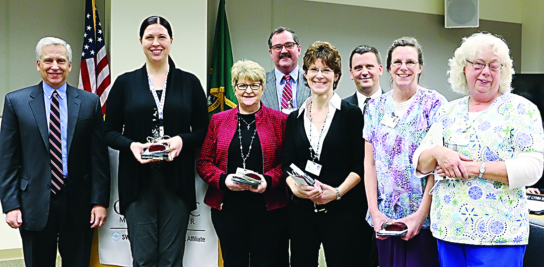 Olympic Medical Center recently recognized five employees for their efforts at the Jan. 6 board of commissioners meeting. In the front row from left are Chief Executive Officer Eric Lewis