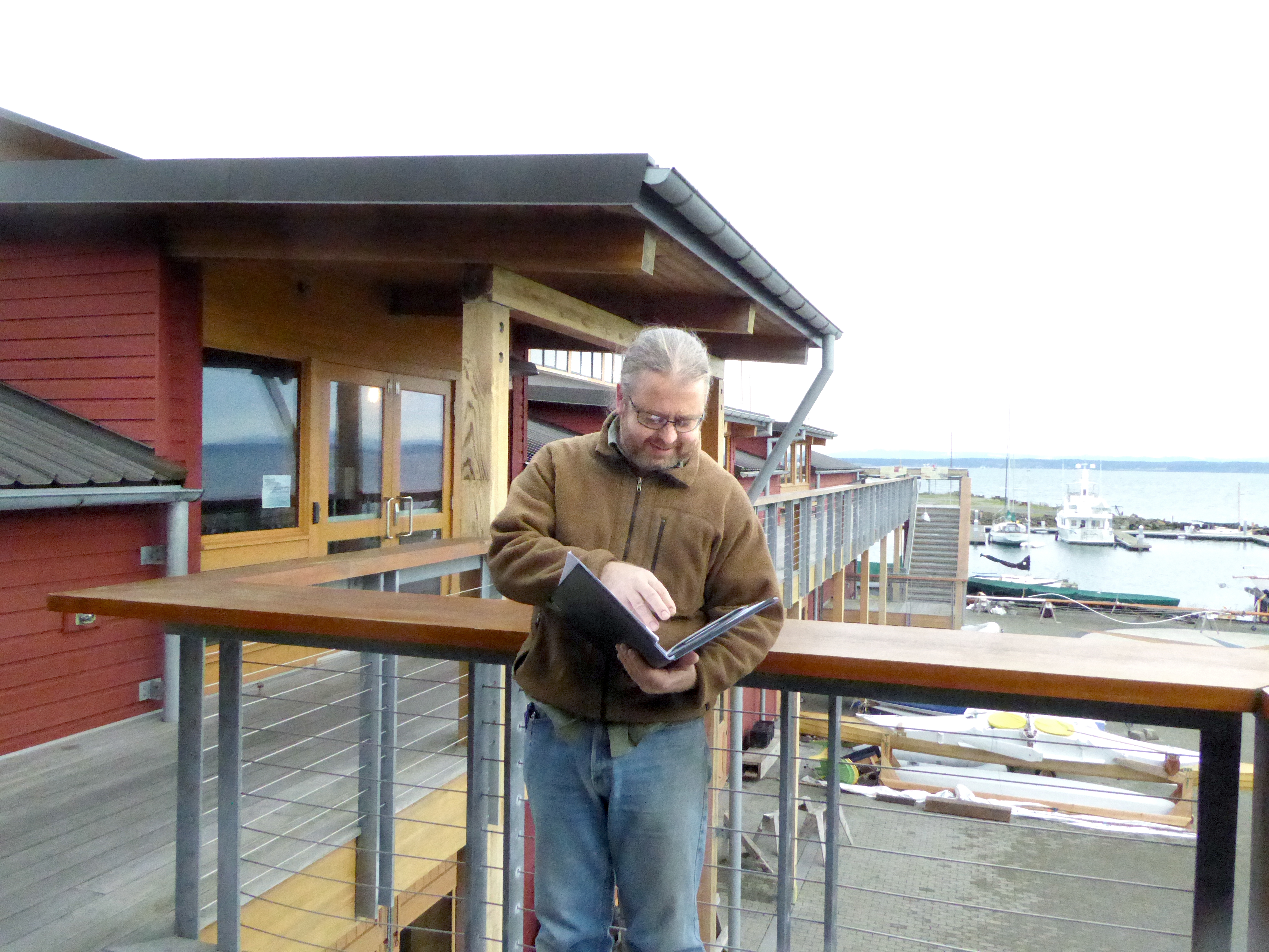 Erik Wennstrom inspects some of the material to be used in tonight’s presentation about water emergencies. — Charlie Bermant/Peninsula Daily News ()