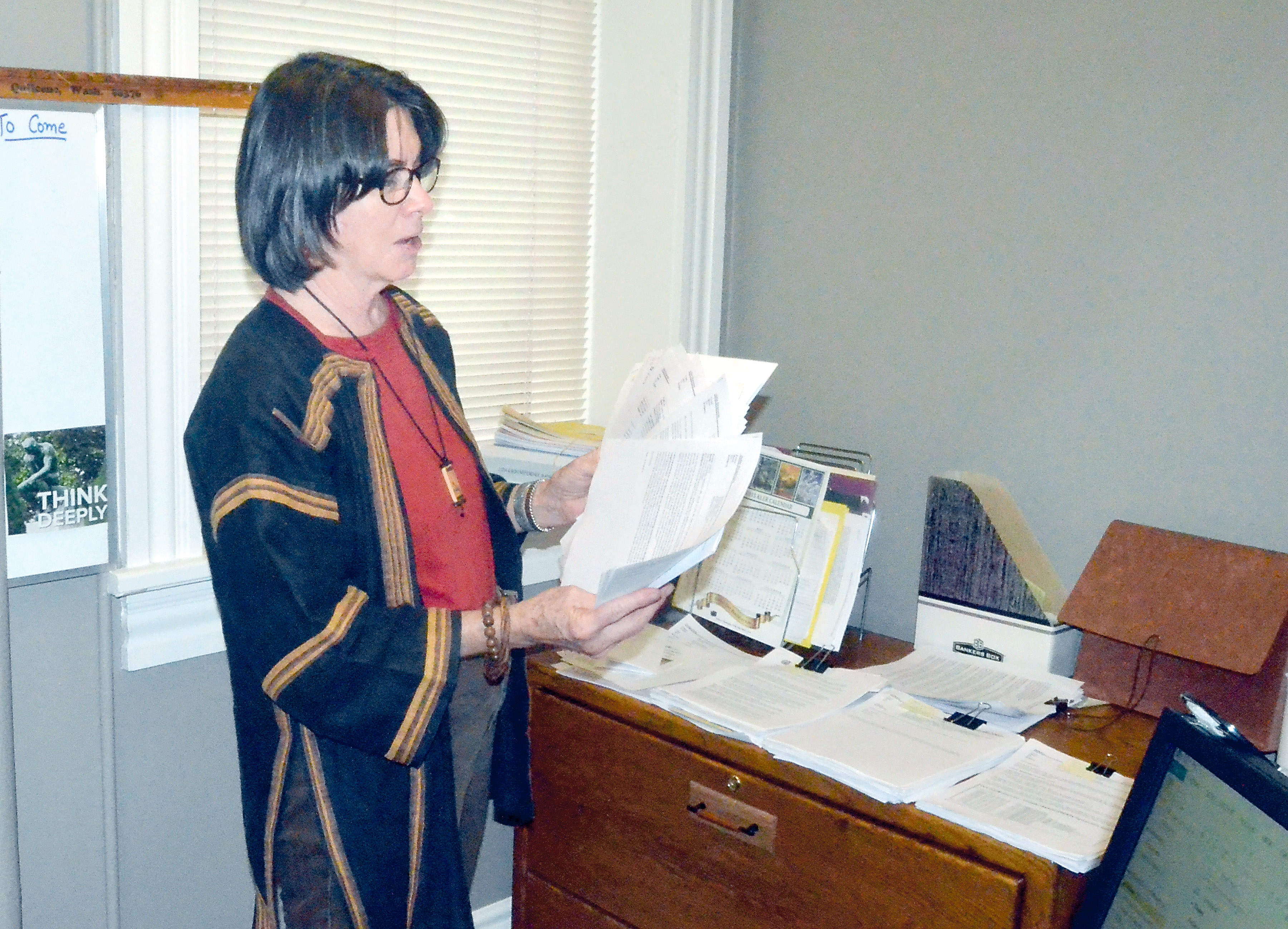 Jefferson County Commissioner Kathleen Kler with the marijuana-related emails received over a two-day period that she was out of the office. (Charlie Bermant/Peninsula Daily News)