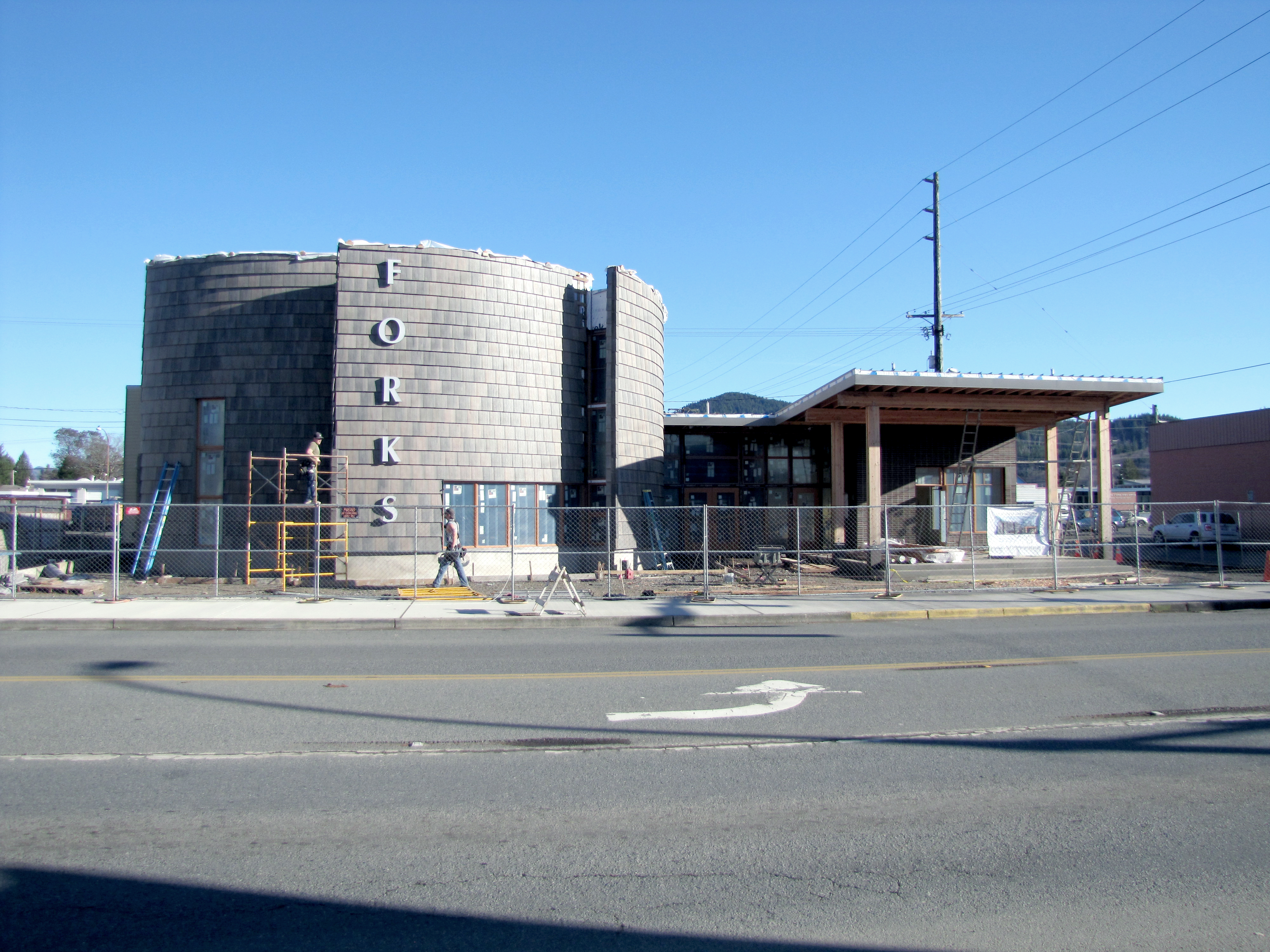 Roofers assemble scaffolding at the Rainforest Arts Center in Forks on Wednesday. The community arts center is on schedule for its grand opening April 18. A tour of the facility is scheduled for Saturday. — Arwyn Rice/Peninsula Daily News ()