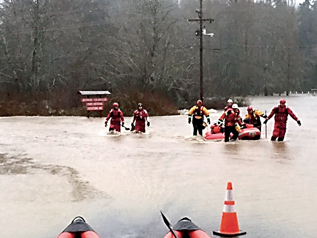 A swift-water rescue team operates with an inflatable boat in the Duckabush floodwaters Friday morning in this photo from Patrick Nicholson of Fire District No. 4 (Brinnon). ()