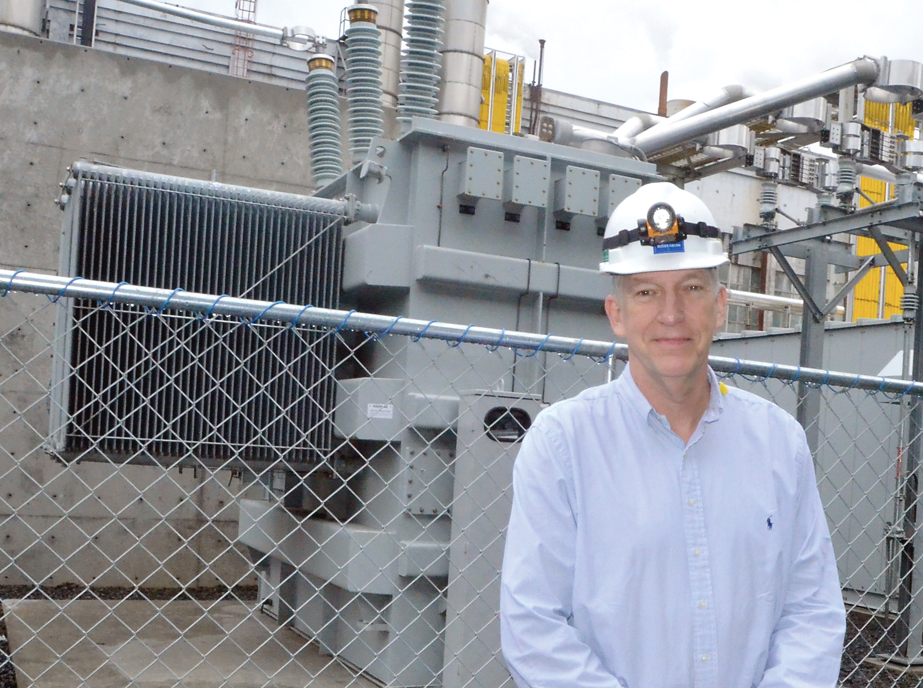 Port Townsend Paper Corp. President Roger Hagen stands in front of the company's new generator. — Charlie Bermant/Peninsula Daily News ()