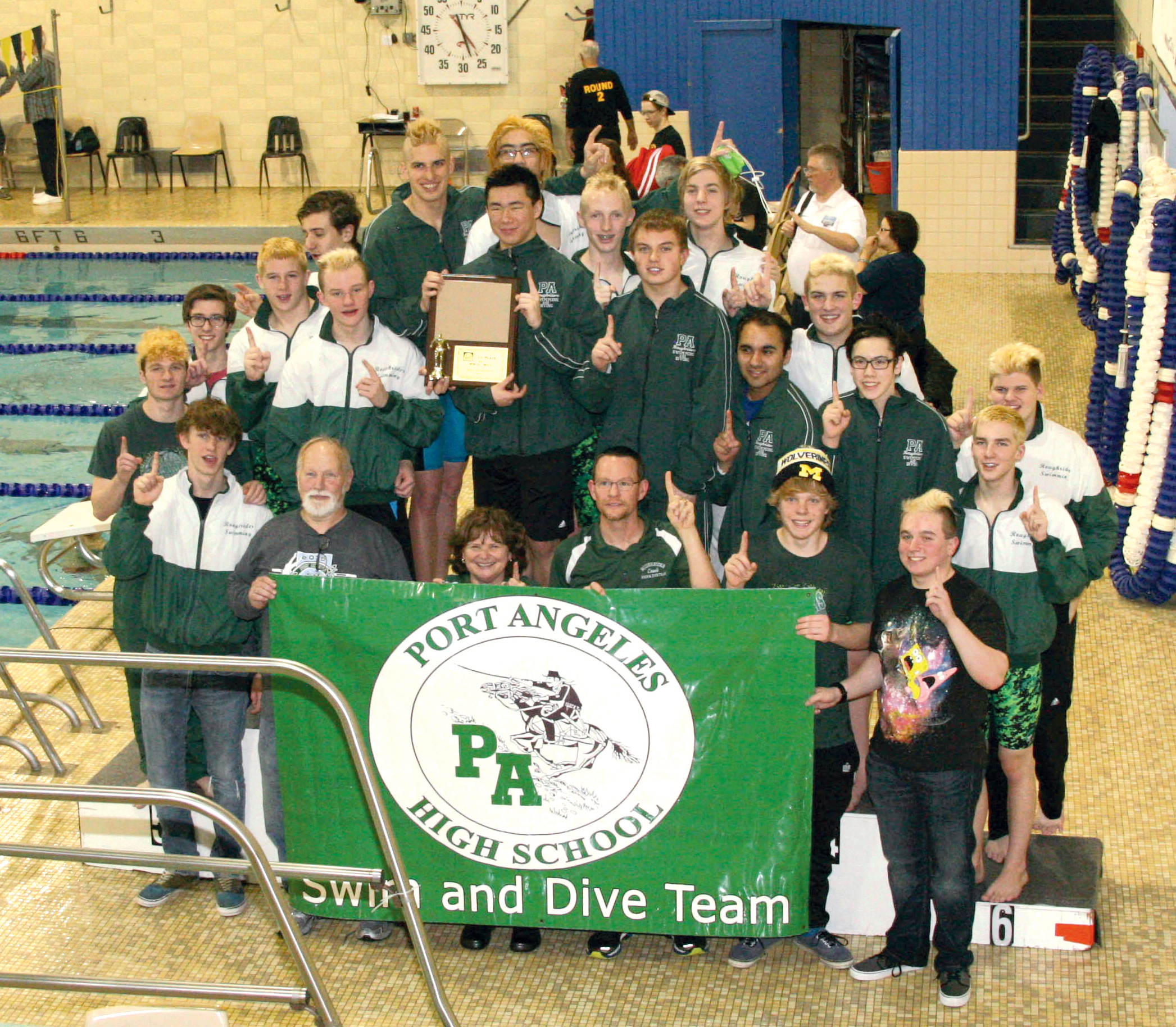 The Port Angeles boys swim and dive team celebrates after winning the West Central District championship at Hazen High School in Renton. The team is: Dario Andereozzi