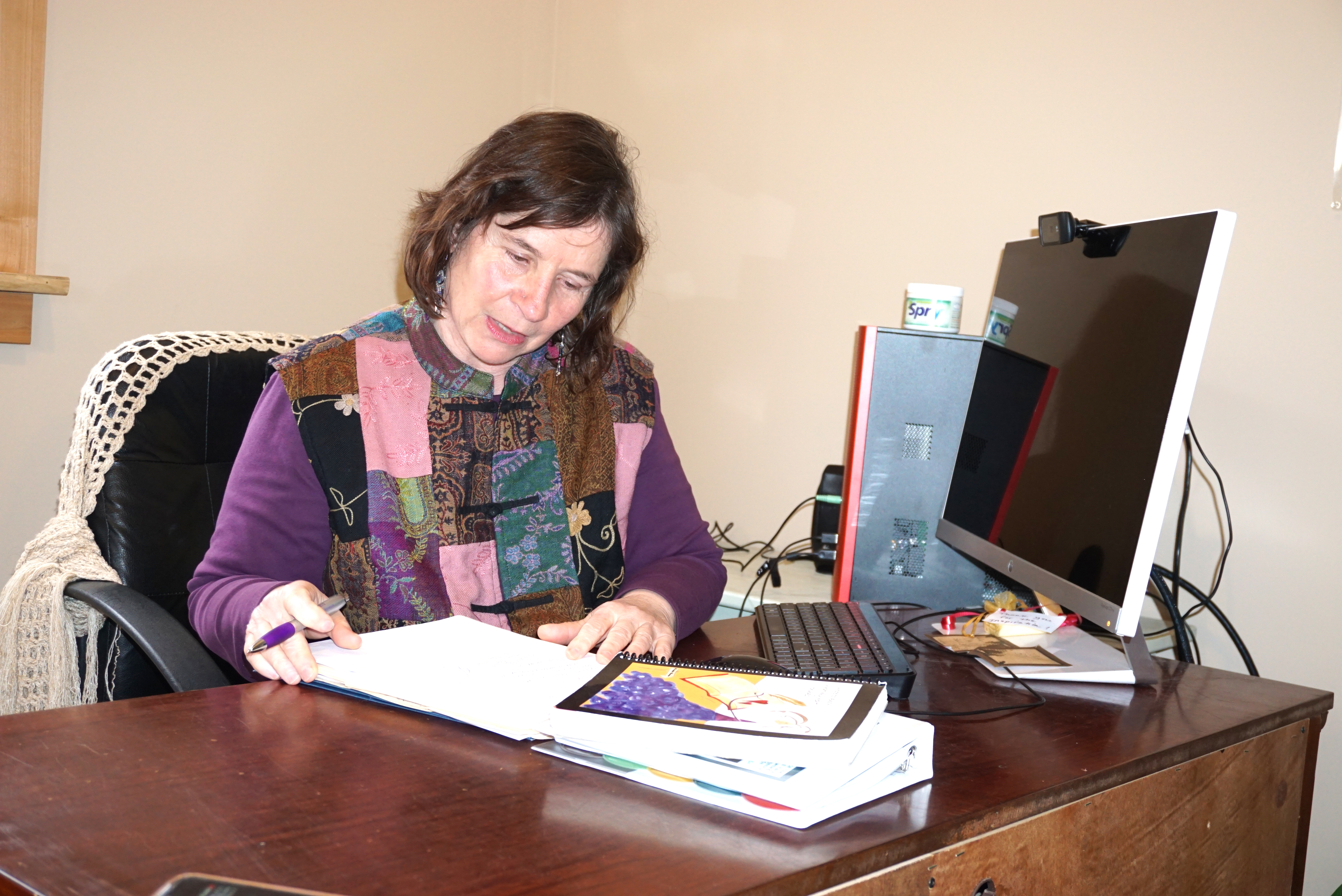 Kippi Waters of the Peninsula Homecare Cooperative catches up on her organization's paperwork. (Charlie Bermant/Peninsula Daily News)